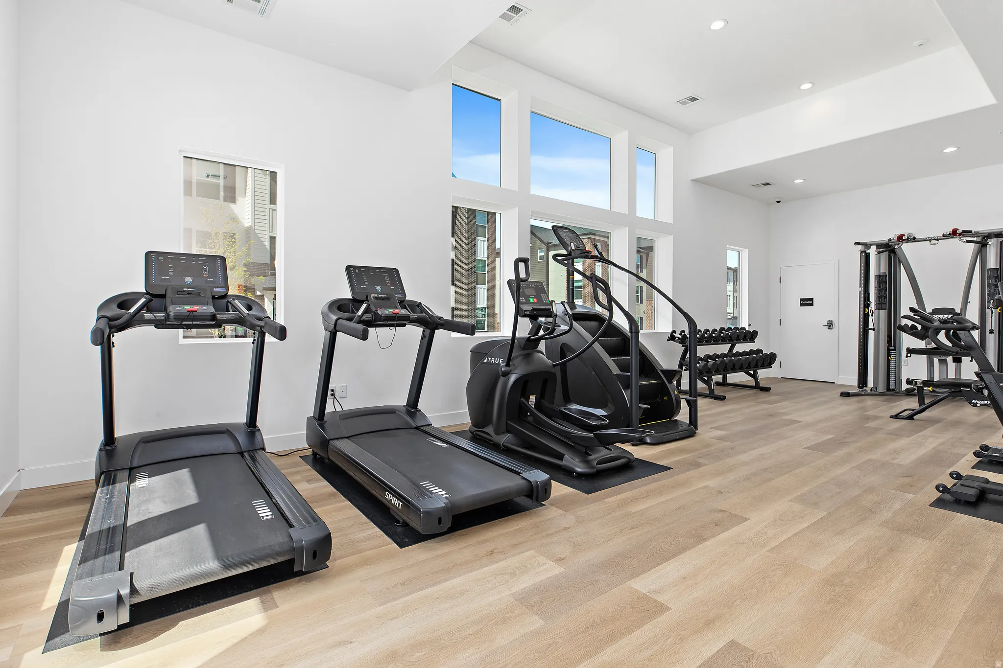 Exercise room featuring a high ceiling and recessed lighting