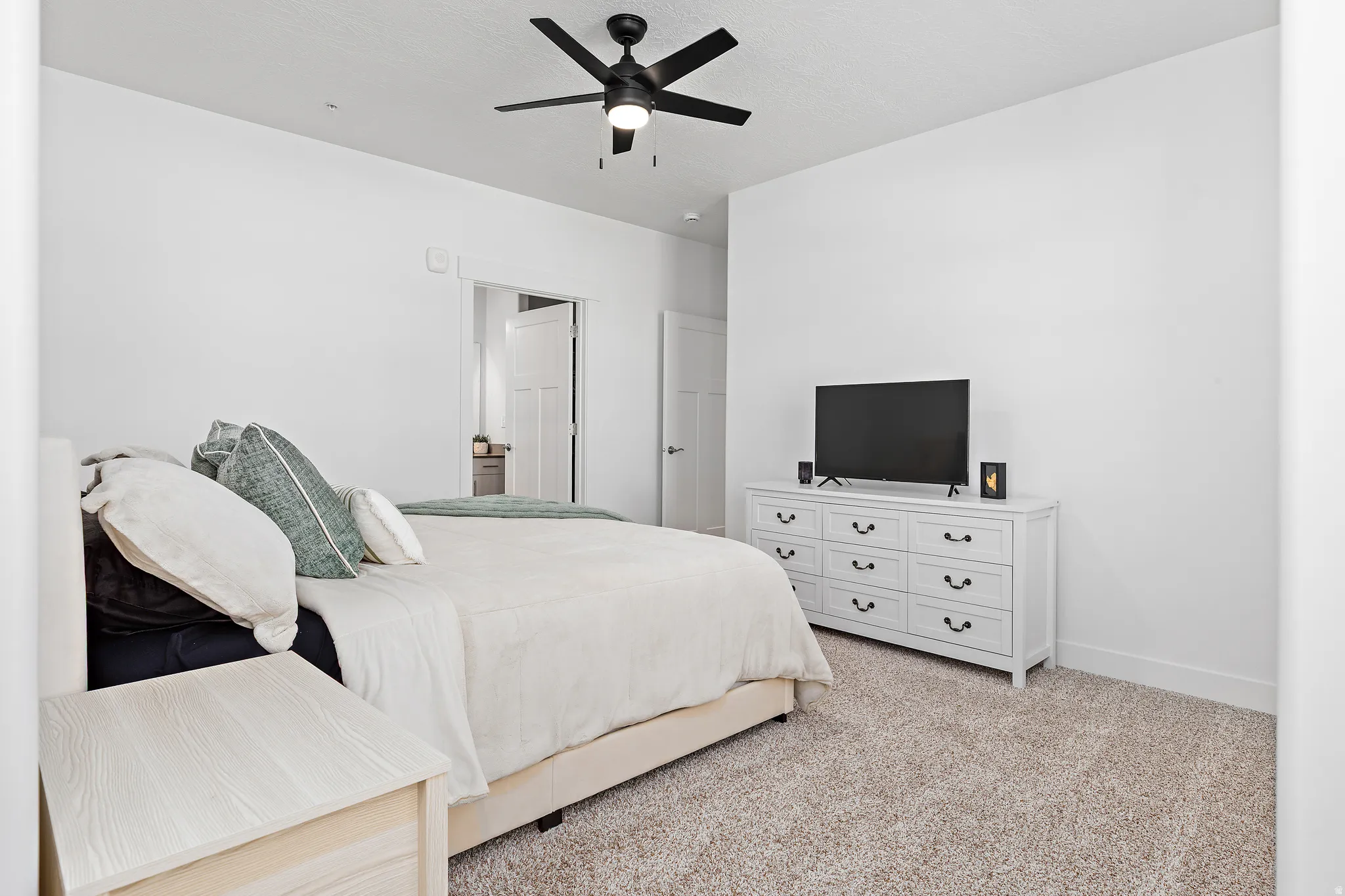 Bedroom with light carpet and ceiling fan