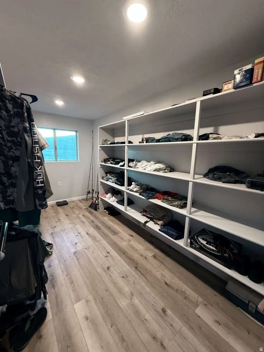 Walk in closet featuring light wood-type flooring