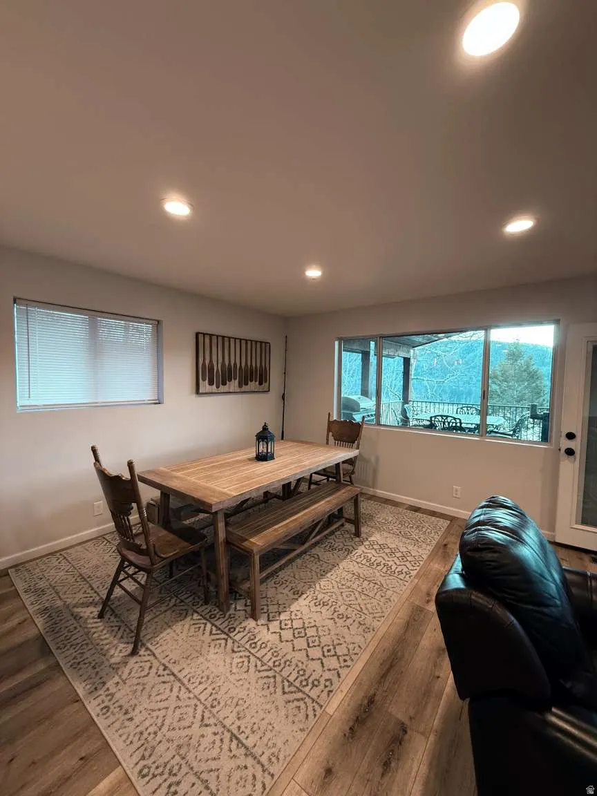 Dining area with hardwood / wood-style floors and recessed lighting