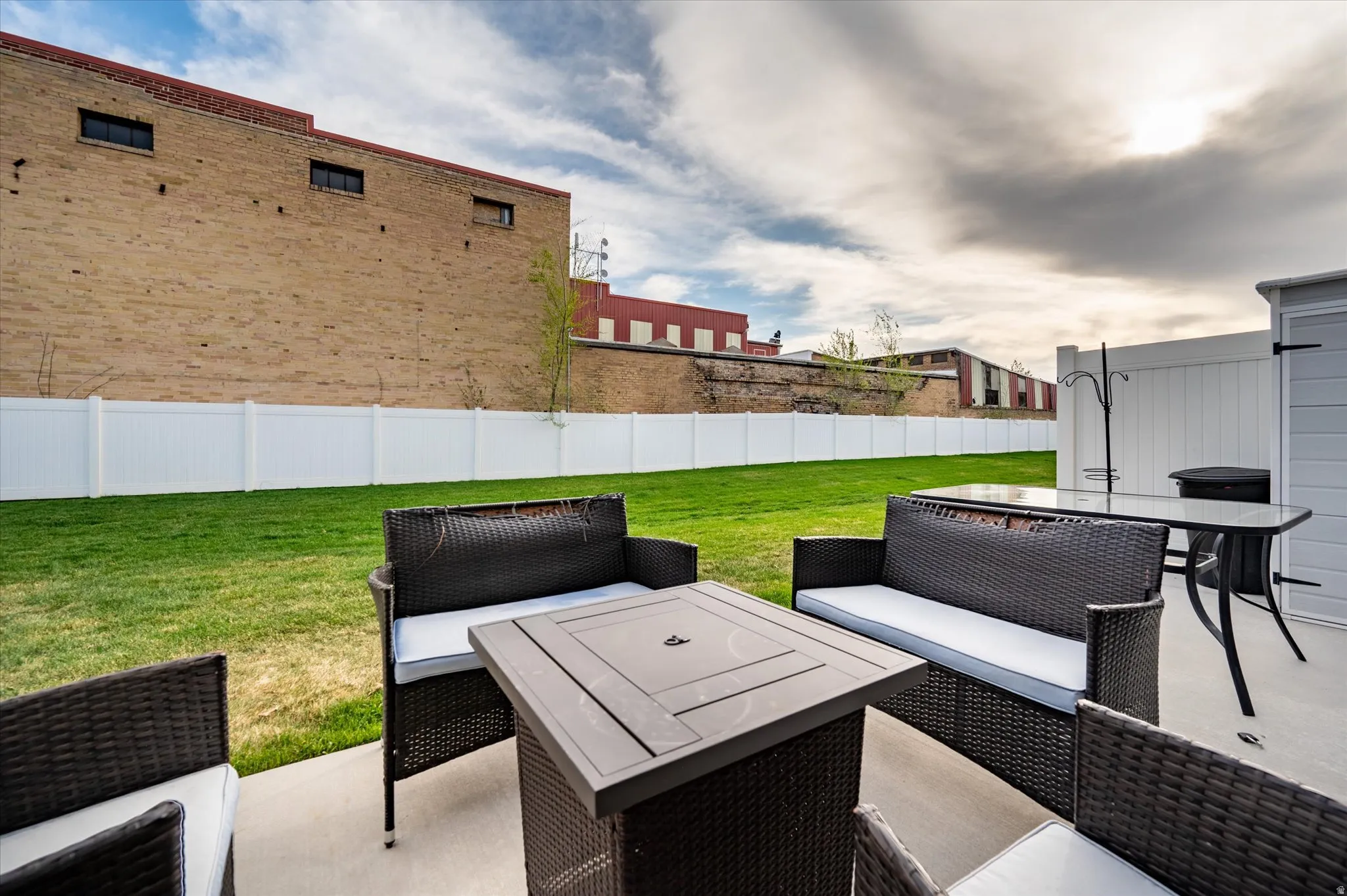 Fenced backyard with a patio and outdoor seating