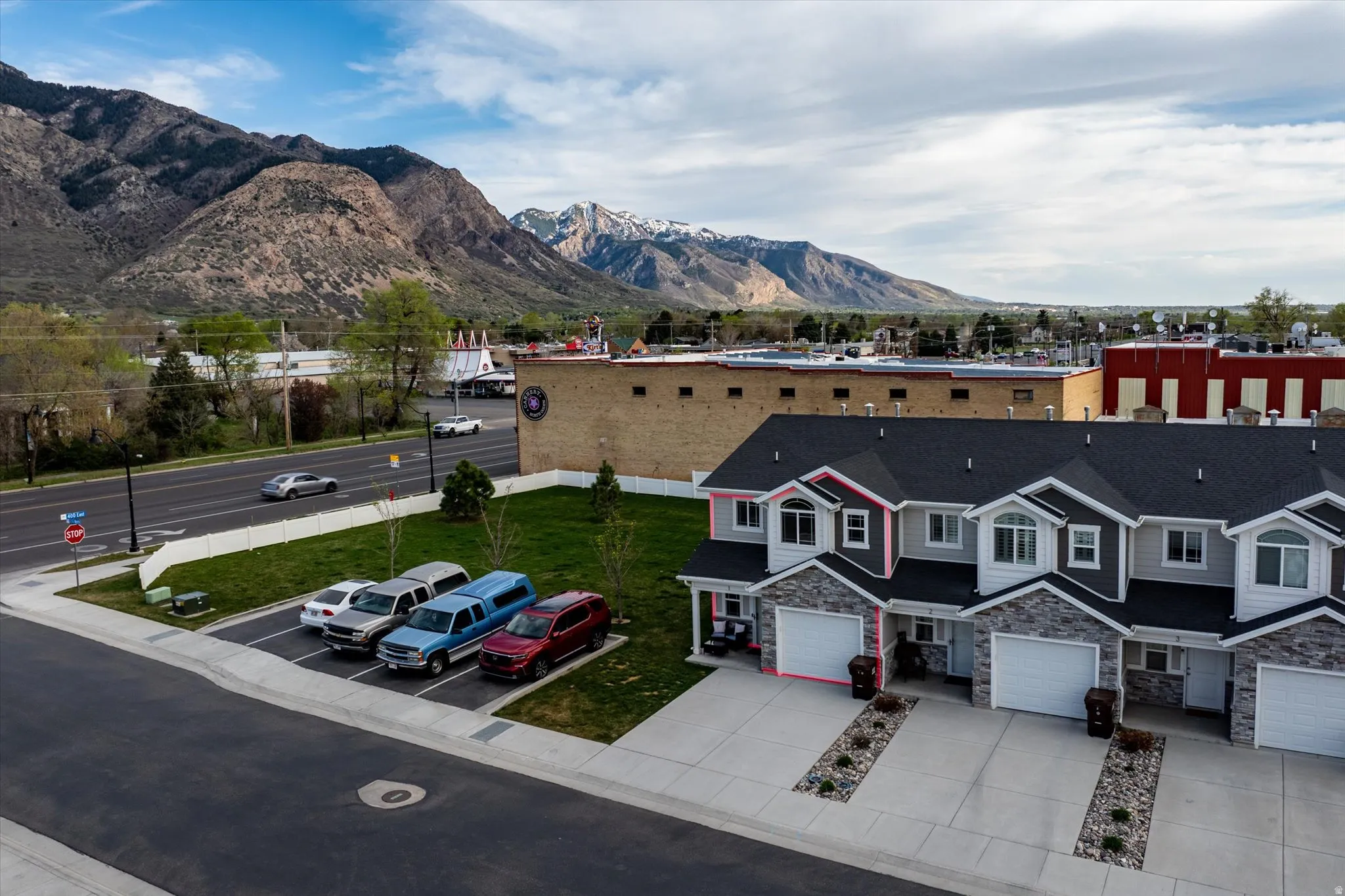 View of Townhome #1, open grass pad, overflow parking, and mountain view.