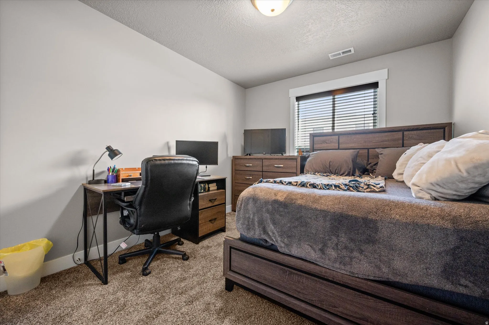Bedroom with double closet doors and lots of natural light.