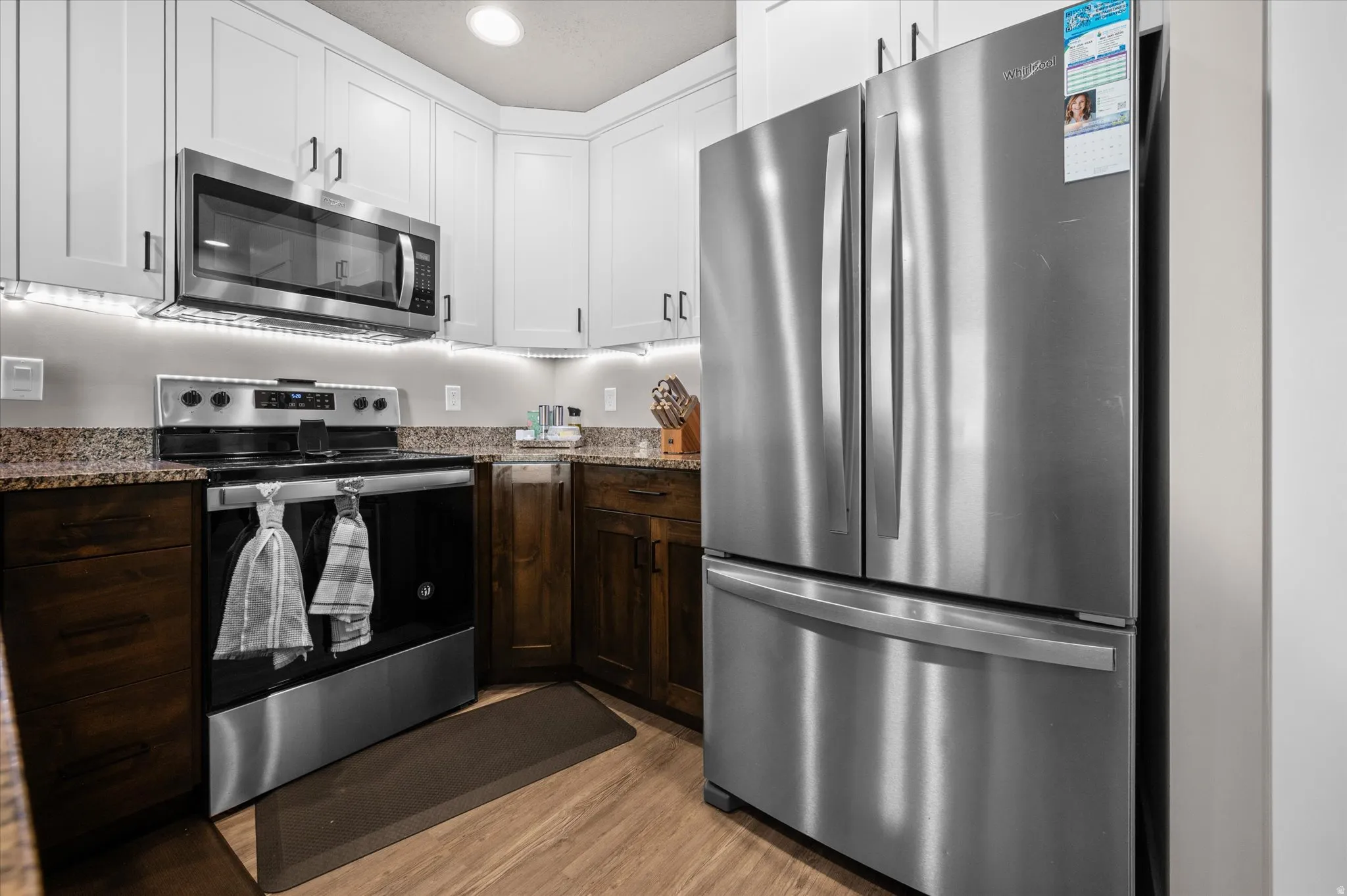 Kitchen featuring stainless steel appliances, granite countertops, and an island for extra eating space.