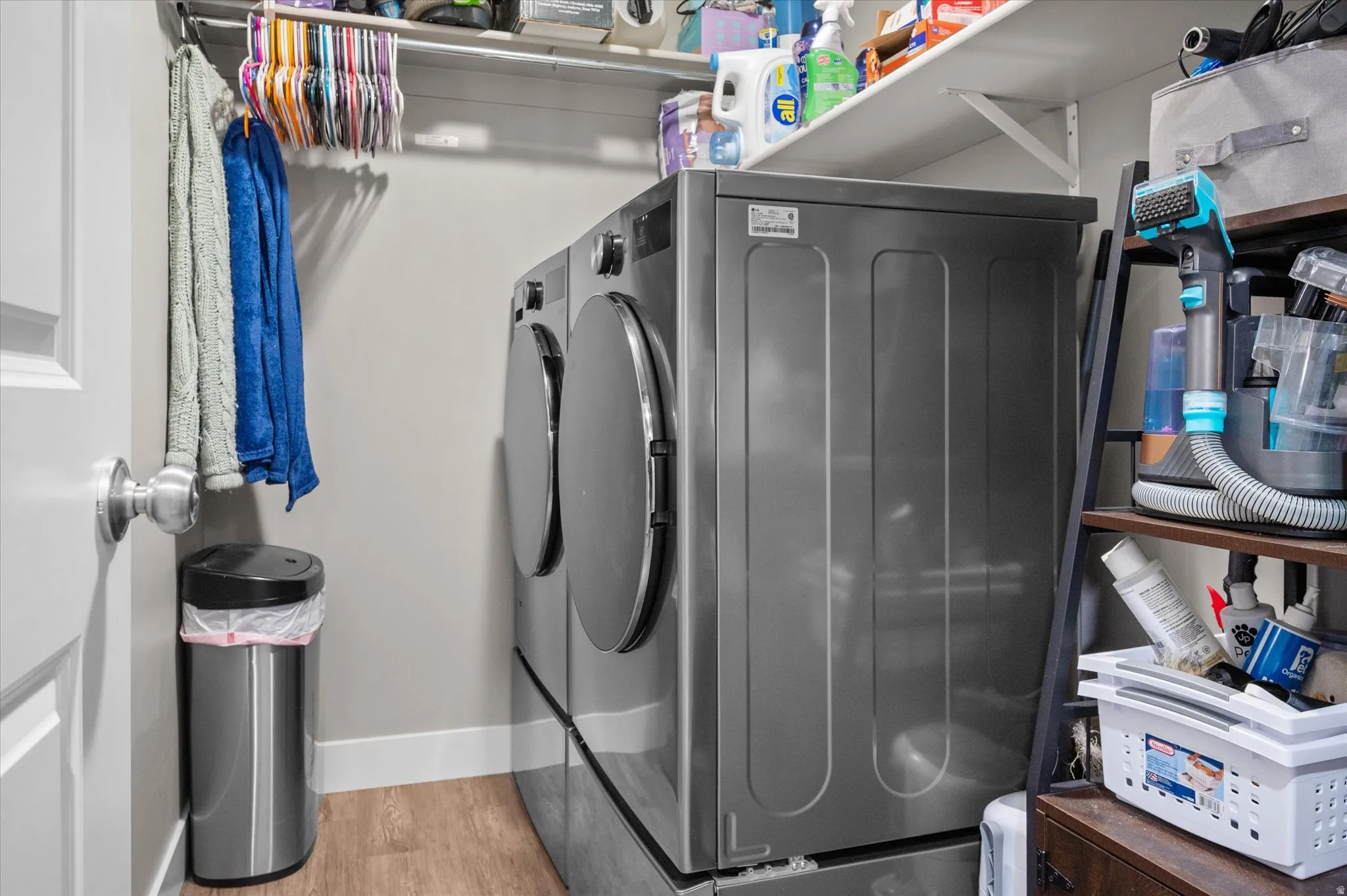 Laundry room with plenty of hanging shelves for organization.
