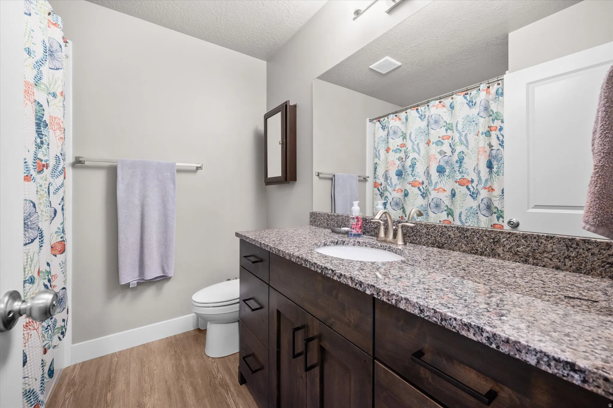 Bathroom with granite vanity, tub/shower, and plenty of counter space.