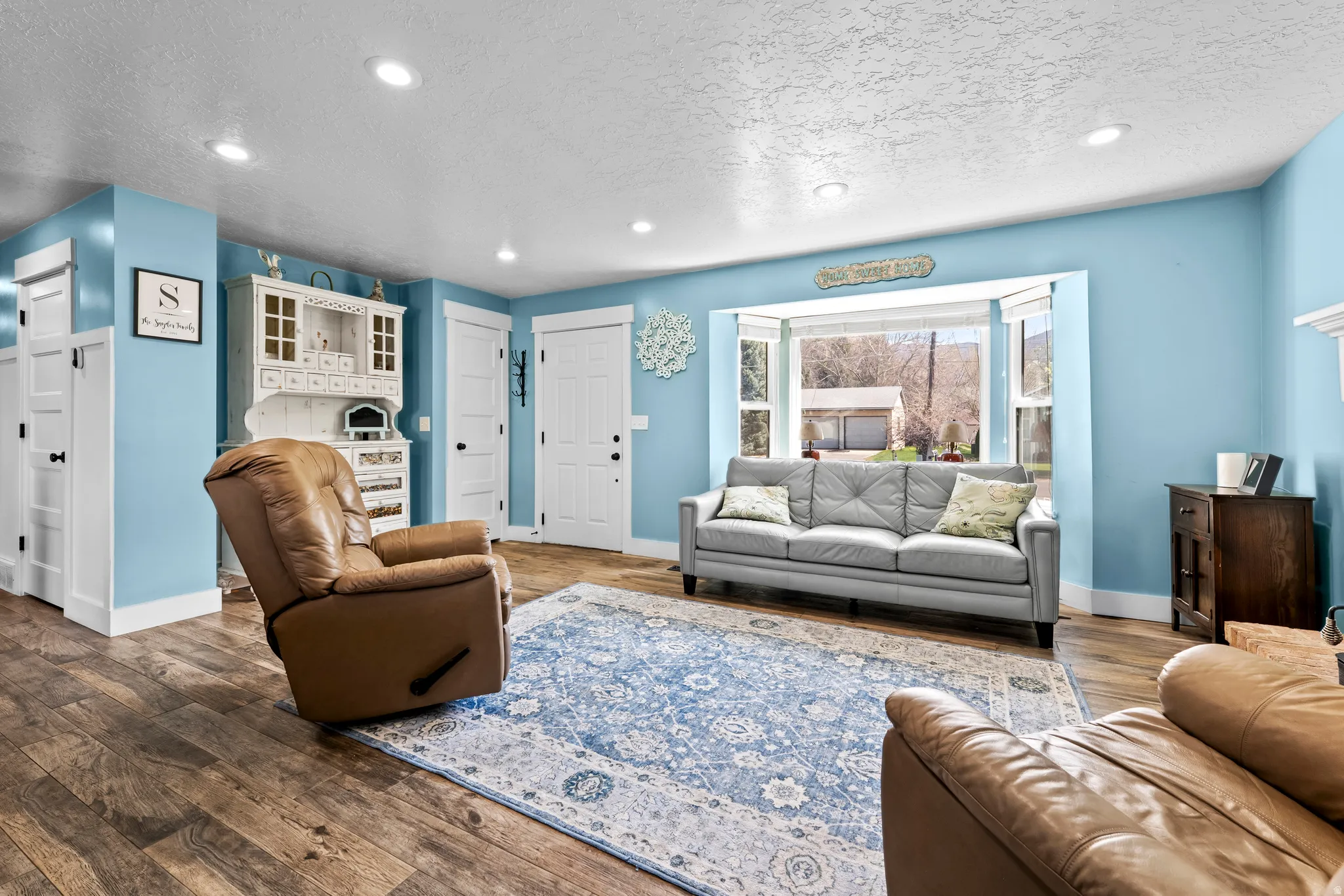 Living room featuring recessed lighting, hardwood / wood-style floors, and a textured ceiling