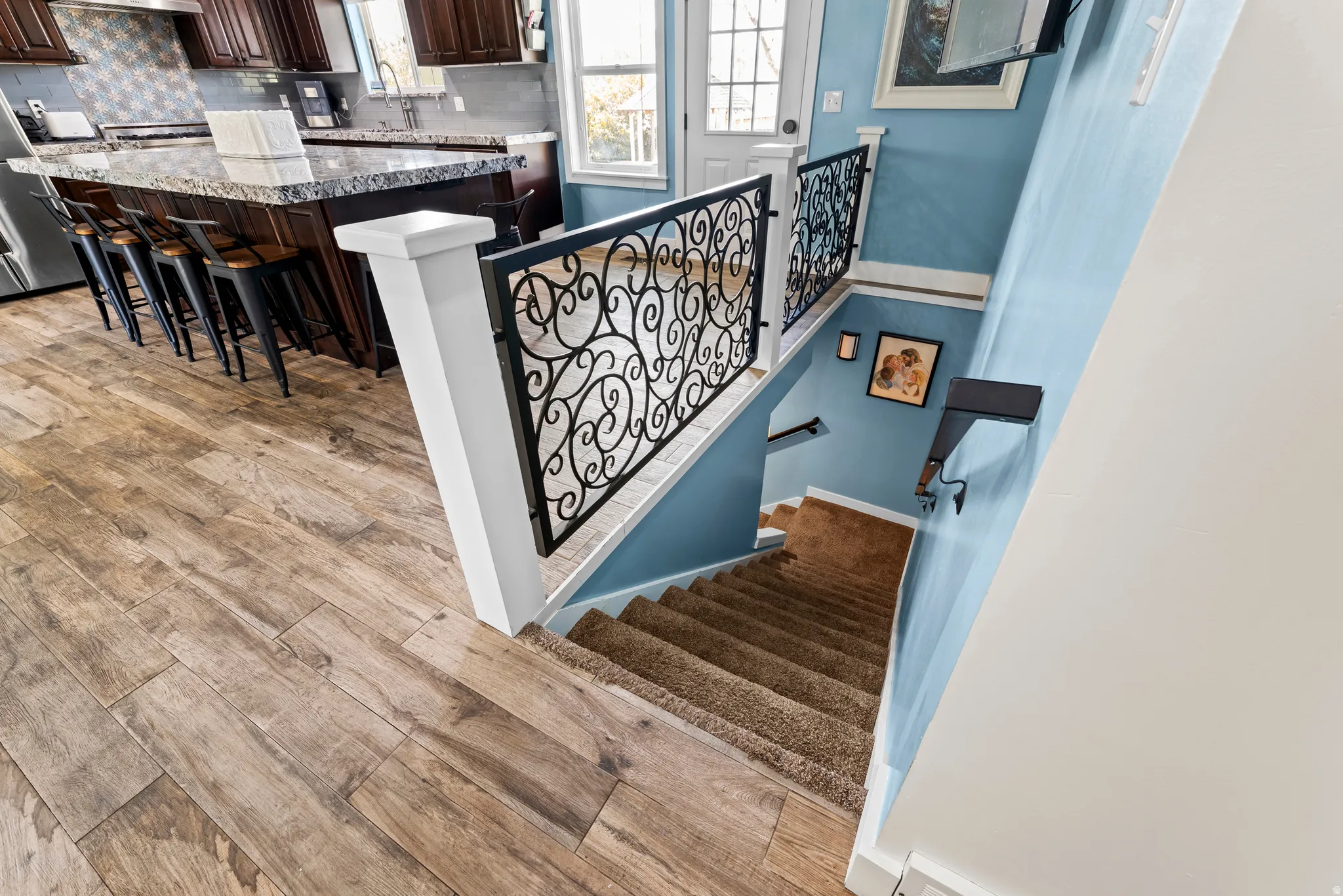 Stairway featuring wood finished floors and baseboards