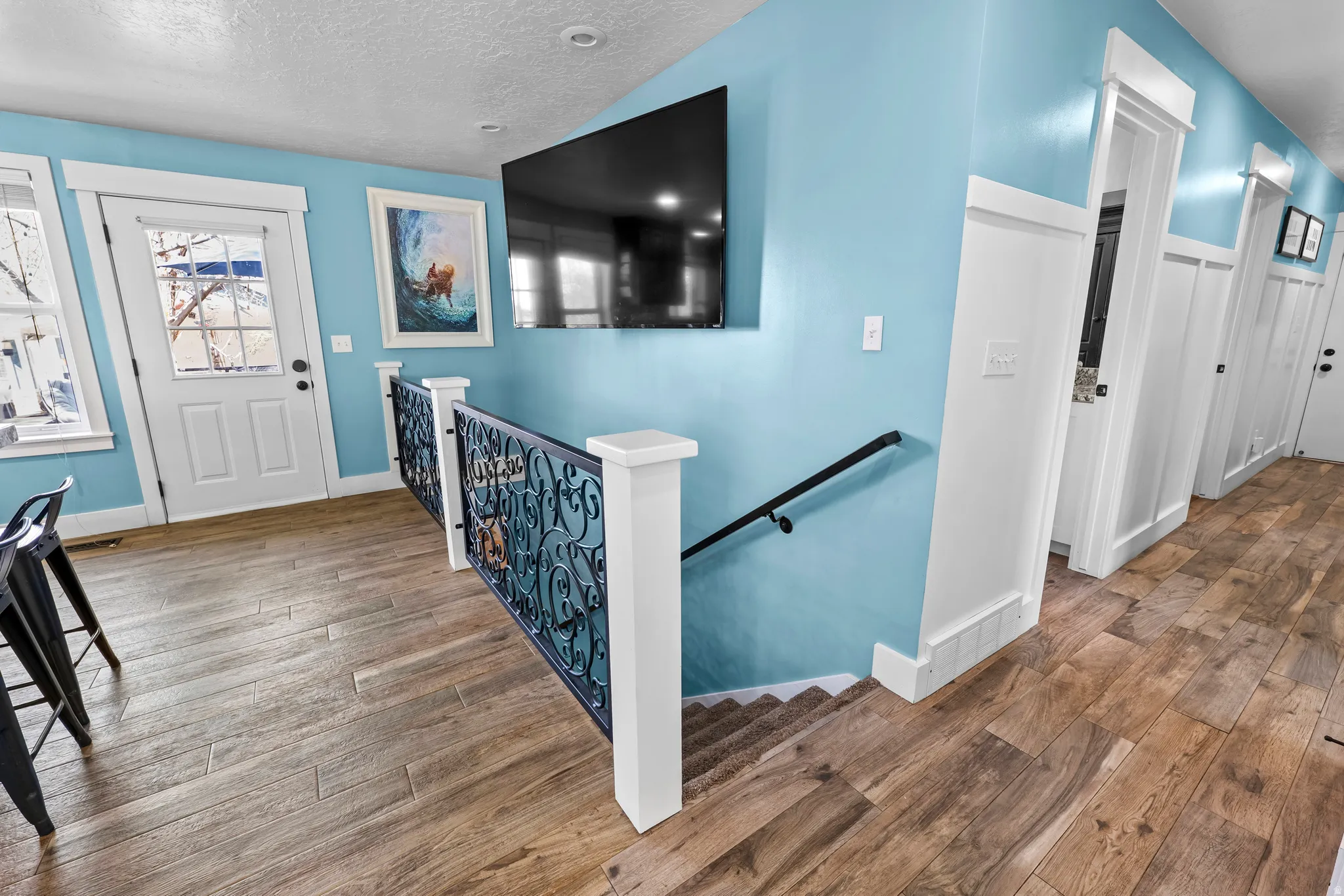 Entrance foyer featuring hardwood / wood-style flooring and baseboards