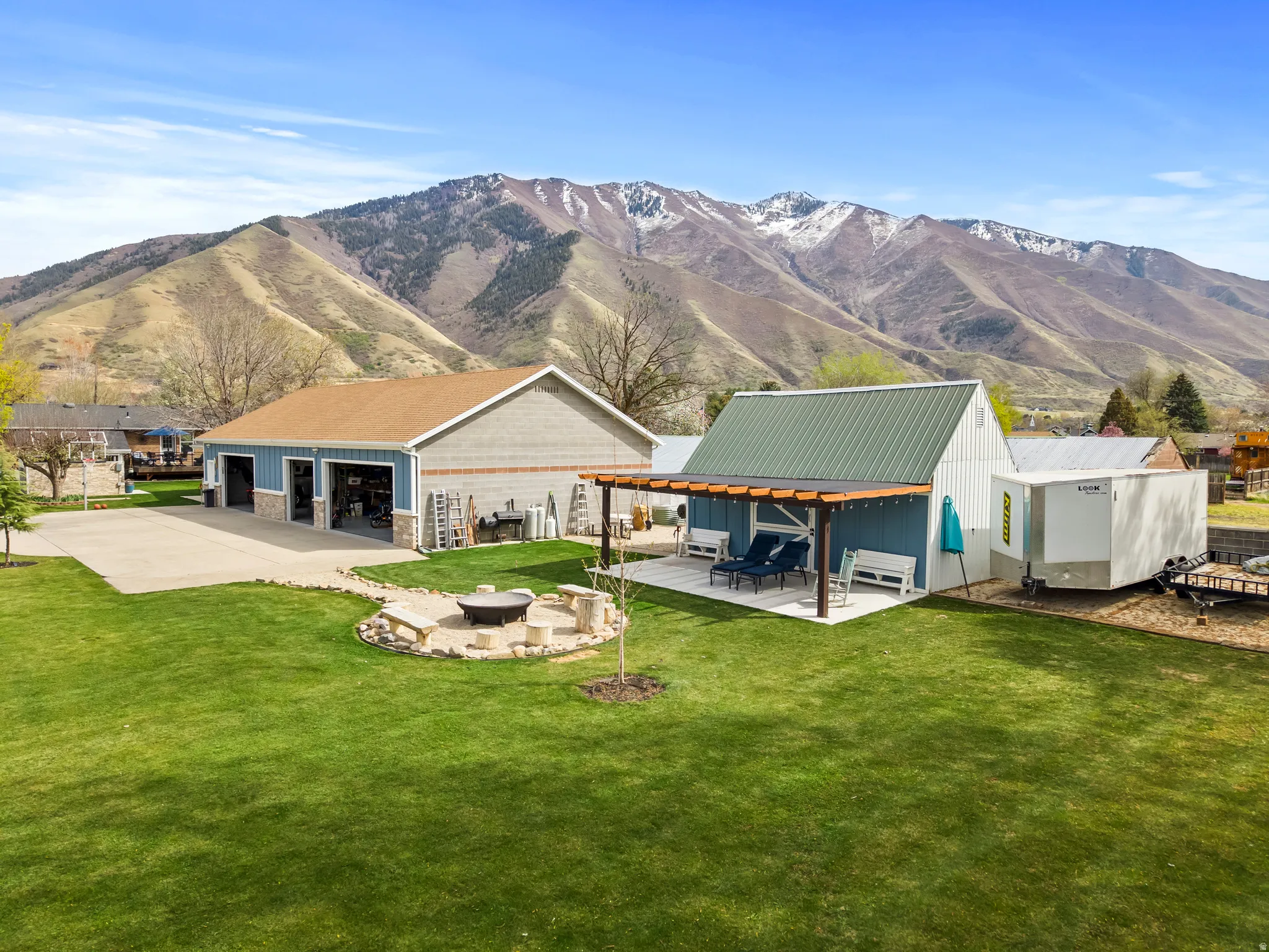 5 car  heated detached workshop with bathroom,  plumbed for compressed air, room for all the toys and tools.  Barn abd firepit are also in the photo.