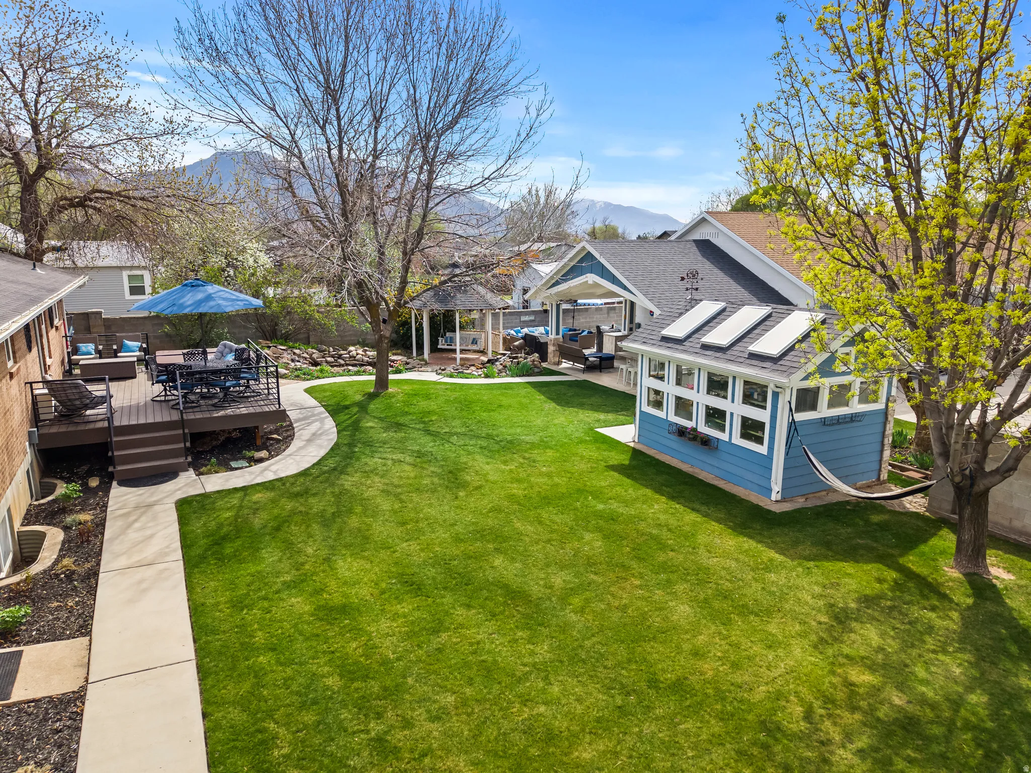 Fenced yard with a patio, a deck with mountain view, and outdoor lounge area