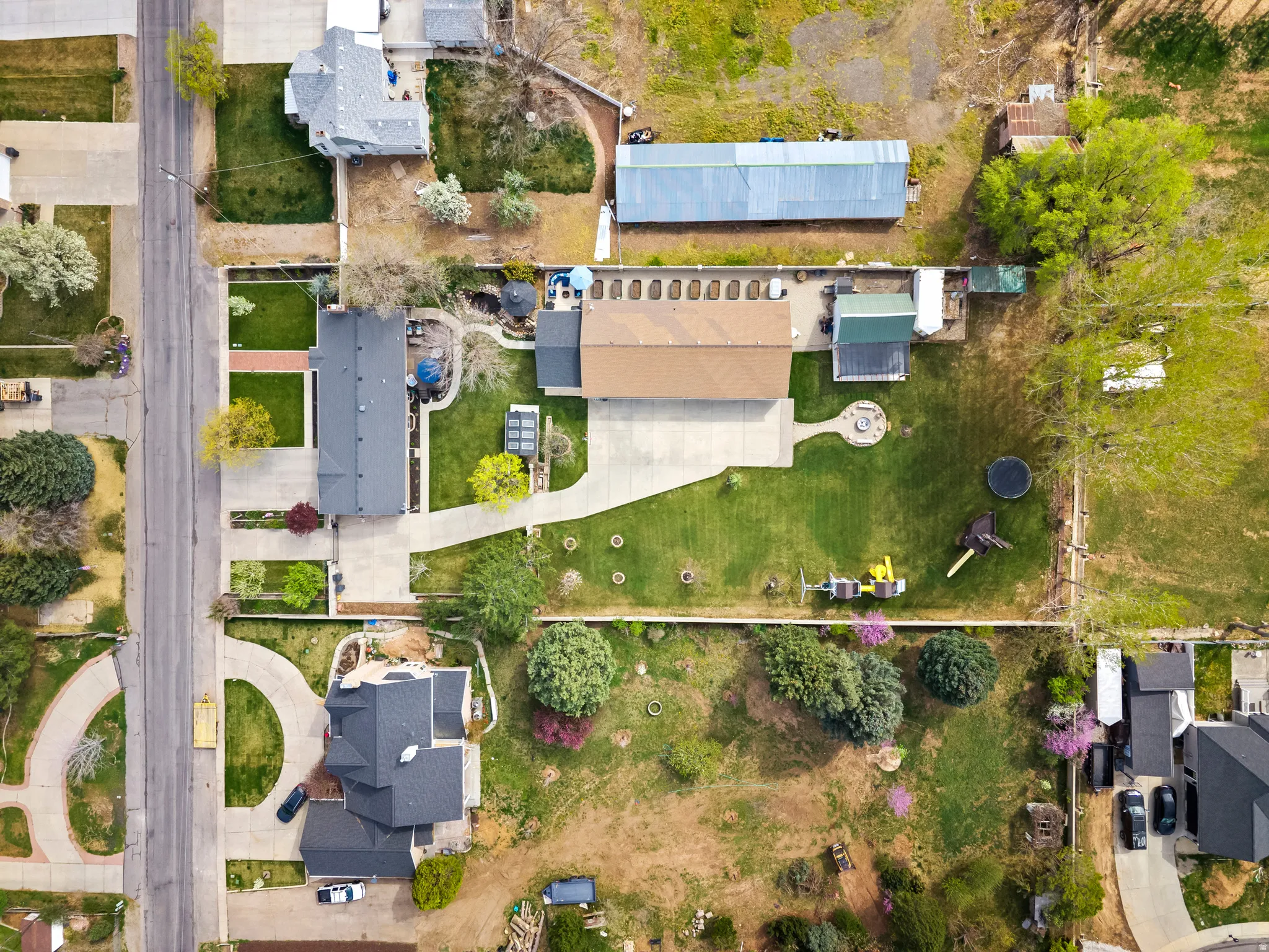 Aerial view of property's location and included buildings along with nearby suburban area