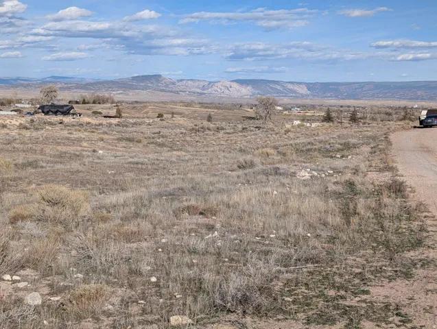 View of mountain backdrop with rural landscape