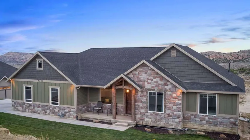 Craftsman house with board and batten siding, a mountain view, stone siding, and covered porch