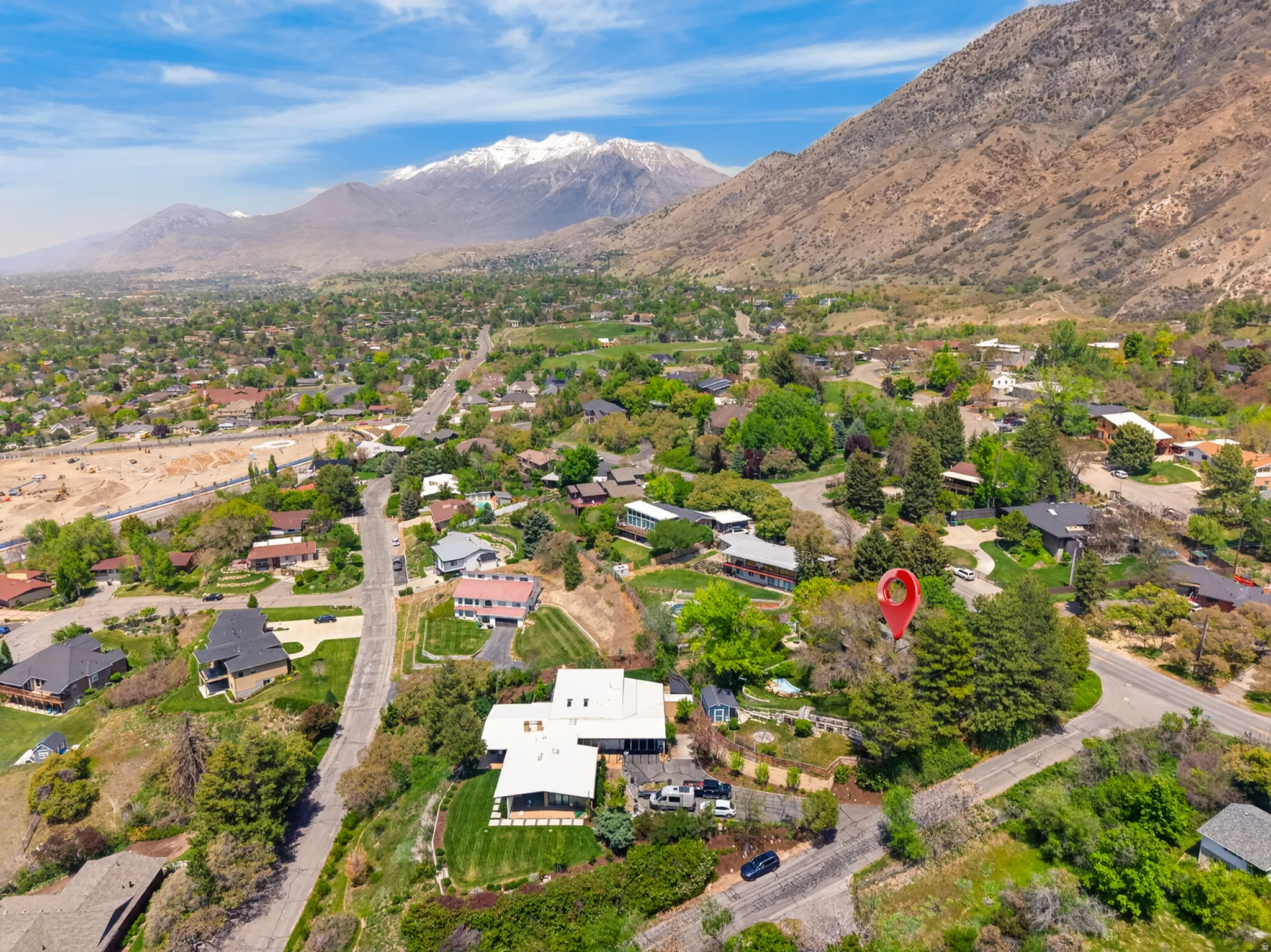 Aerial perspective showcasing a residential area with a prominent mountain backdrop