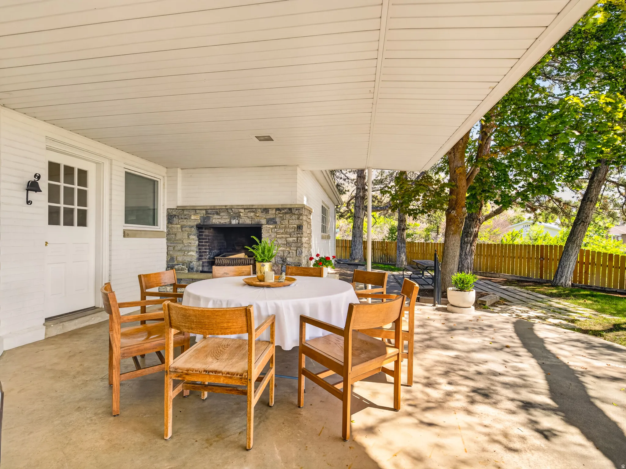 Outdoor dining next to cozy fireplace