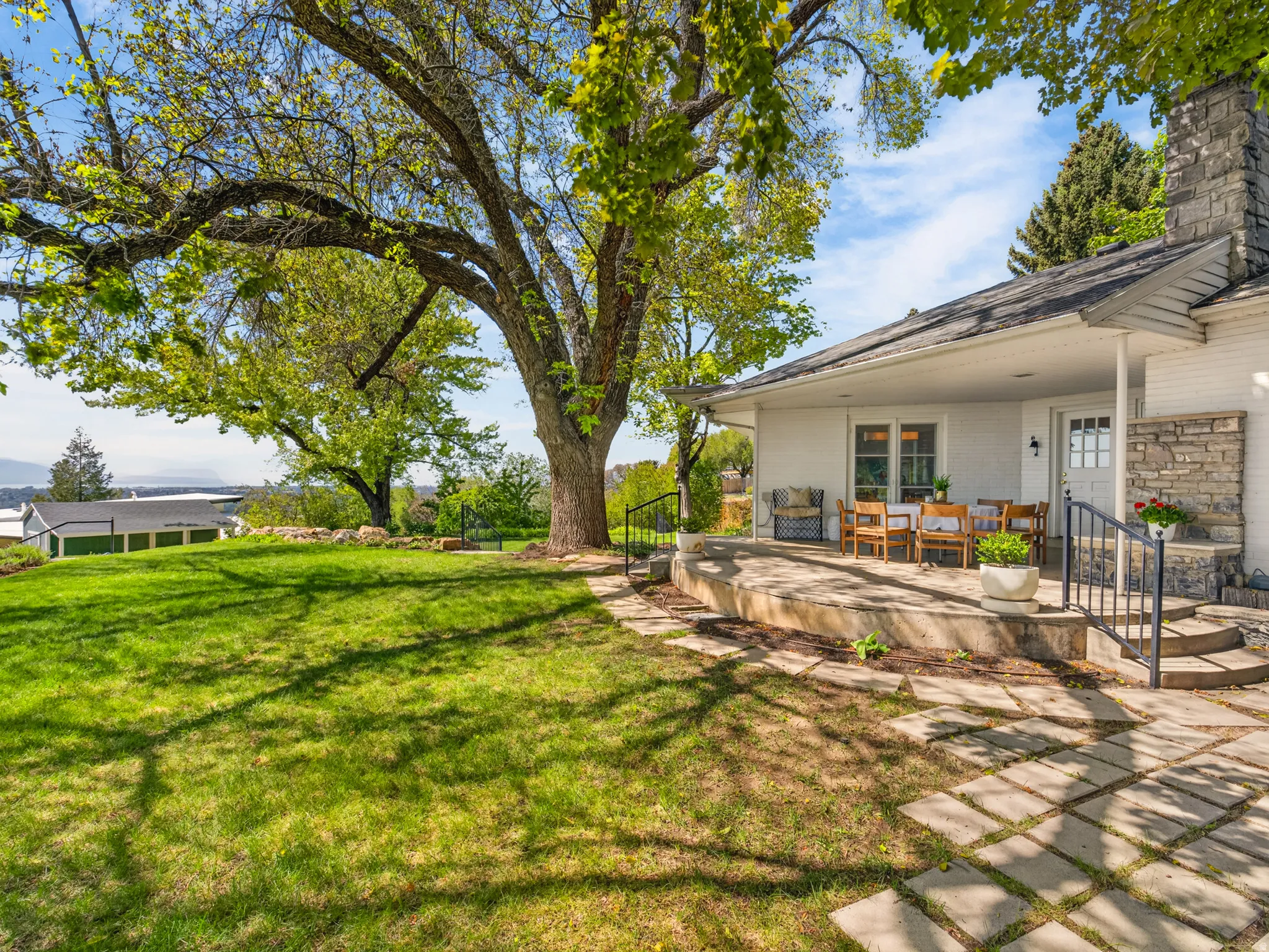 Expansive lawn area featuring mature trees