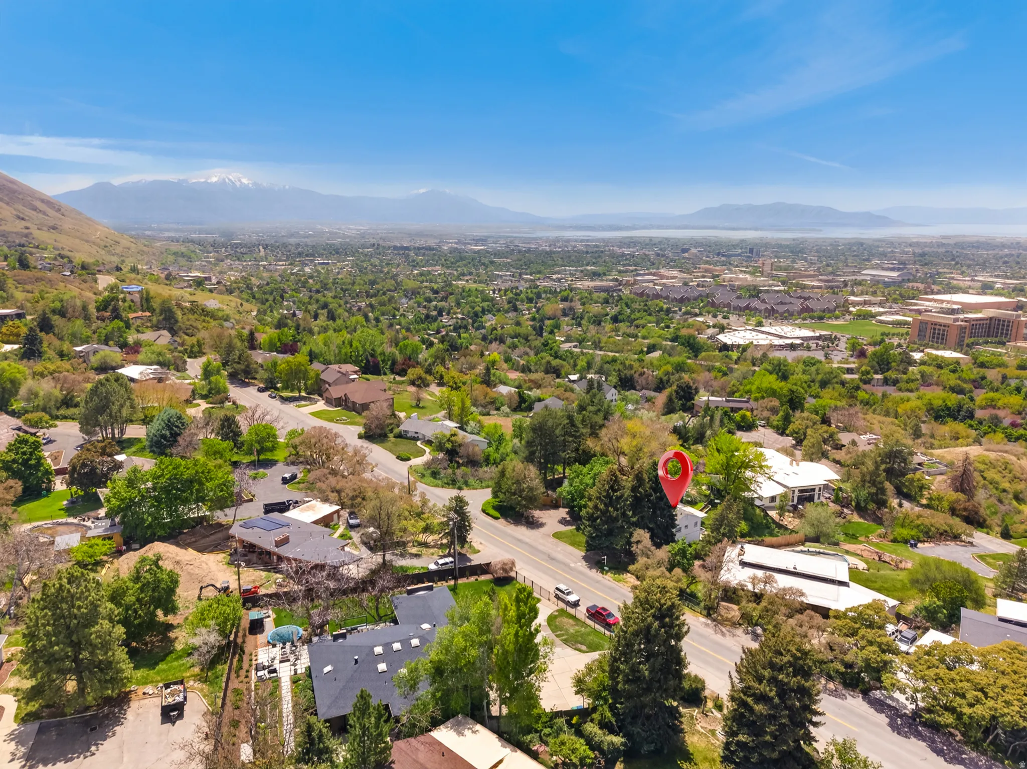 Aerial perspective showcasing a residential area with varied home styles and mature trees