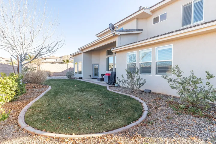 Back of house with stucco siding and a patio area
