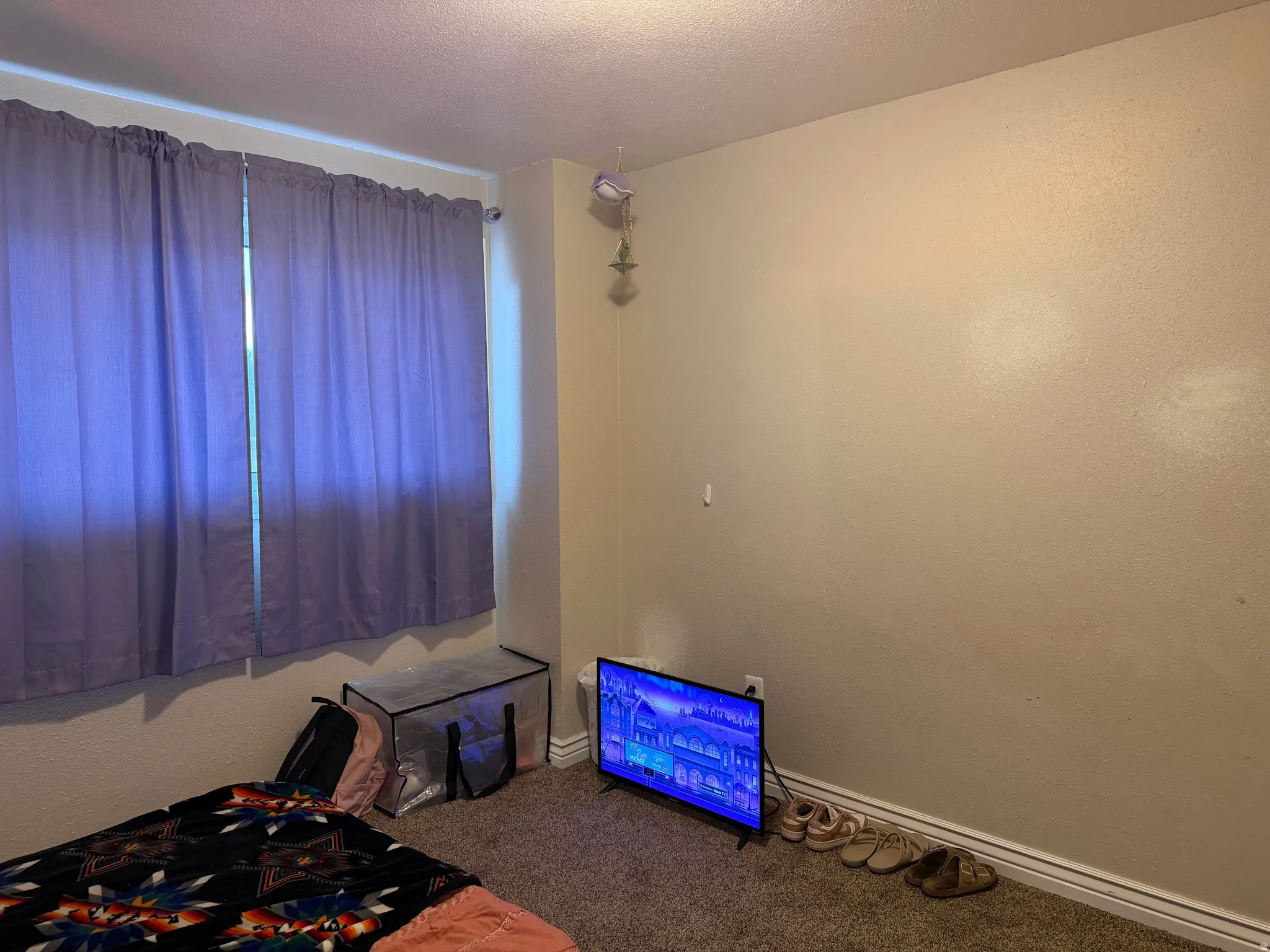 Unfurnished bedroom featuring carpet flooring and a textured ceiling