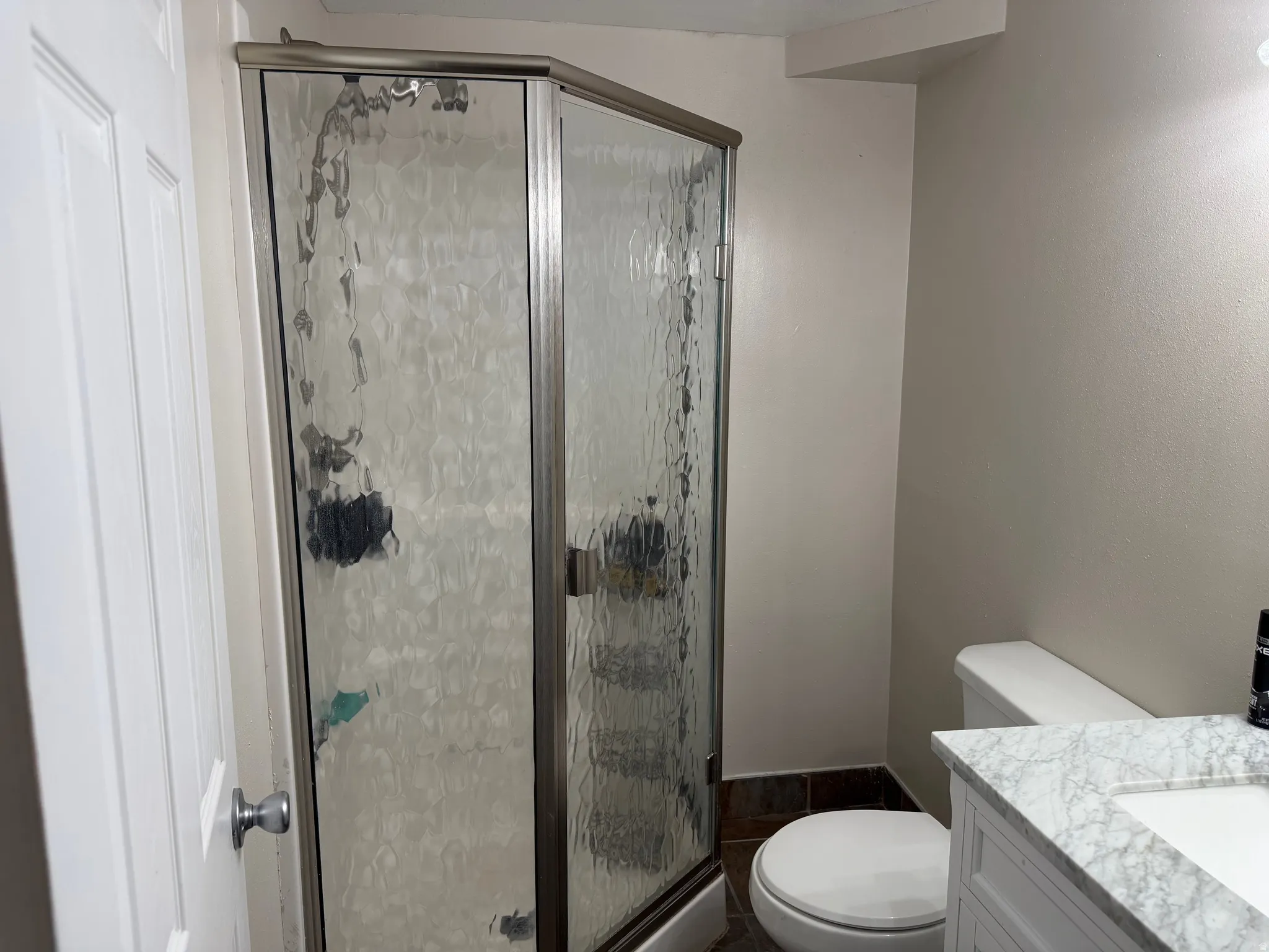 Bathroom featuring vanity and a shower stall