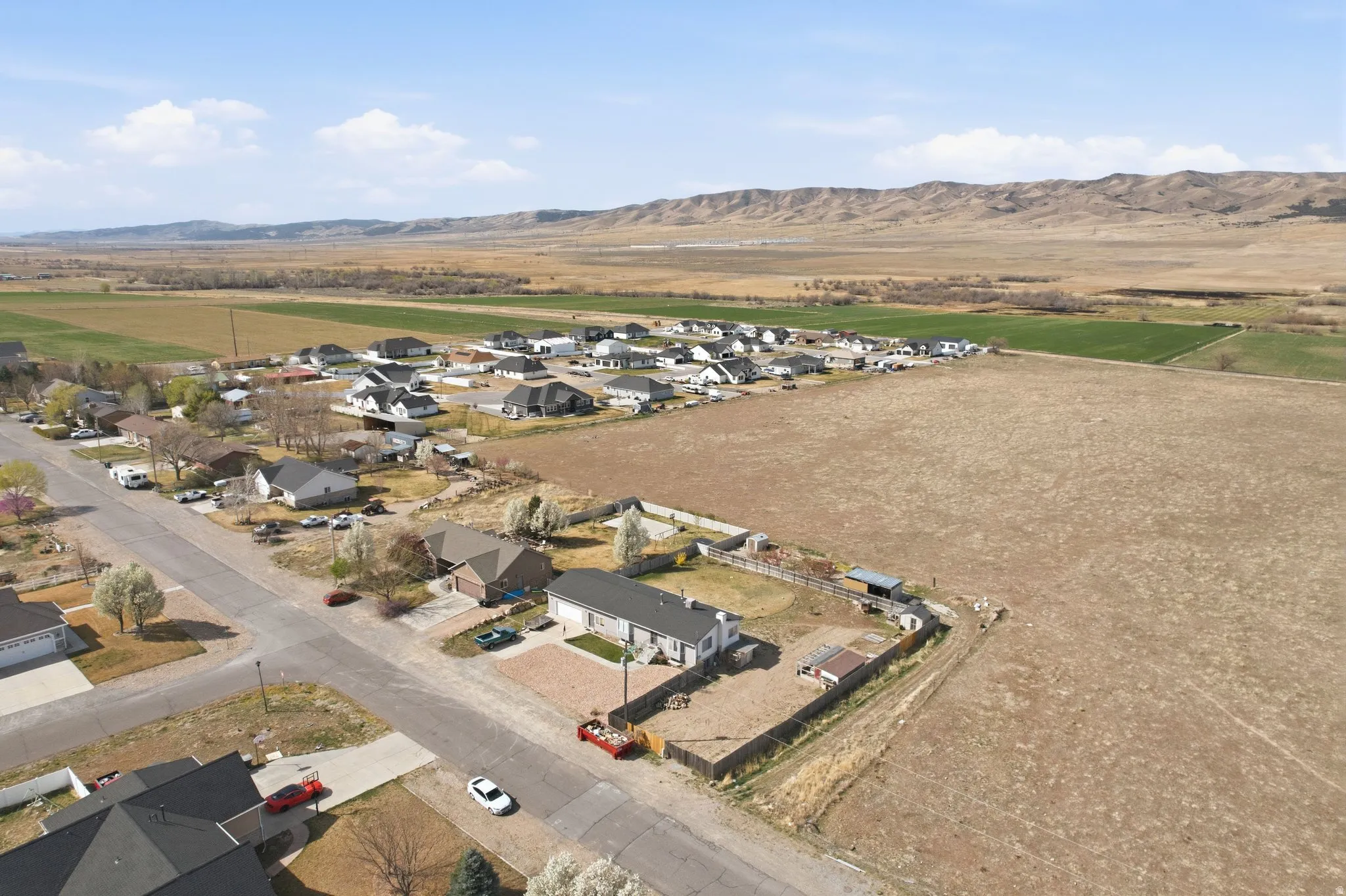 Aerial overview of property's location featuring nearby suburban area and a mountainous background
