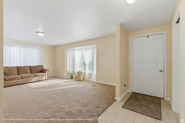 Step into this bright and inviting living room, where large windows fill the space with natural light. The open layout creates a warm, welcoming atmosphere, perfect for relaxing or entertaining guests.