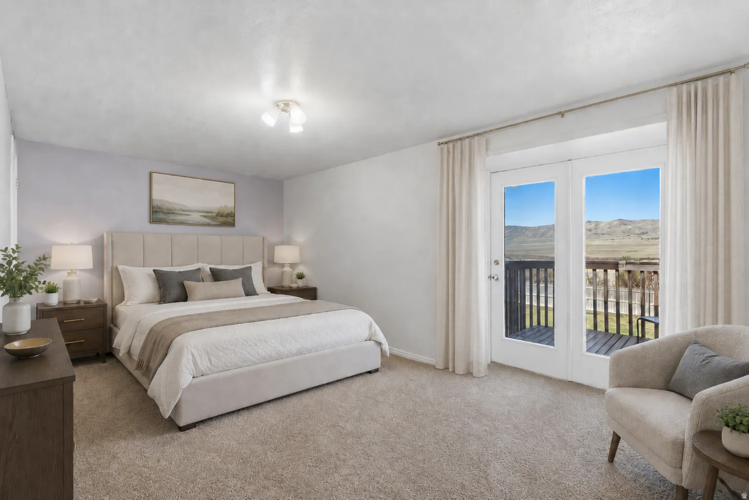 Virtually Staged #1 Primary bedroom featuring a double-door exterior entrance to a private deck. You'll enjoy stunning sunsets and beautiful mountain views!!!