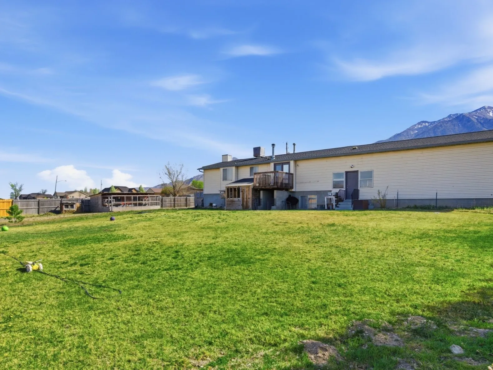 Rear view of house with a fenced backyard