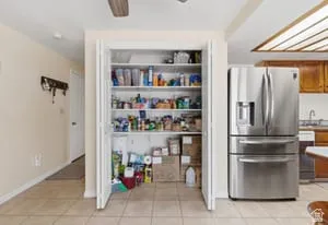 Spacious pantry featuring white framed cabinetry with multiple shelves, ample storage for dry goods and pantry staples, AND IT ALSO HAS WASHER & DRYER HOOKUPS!