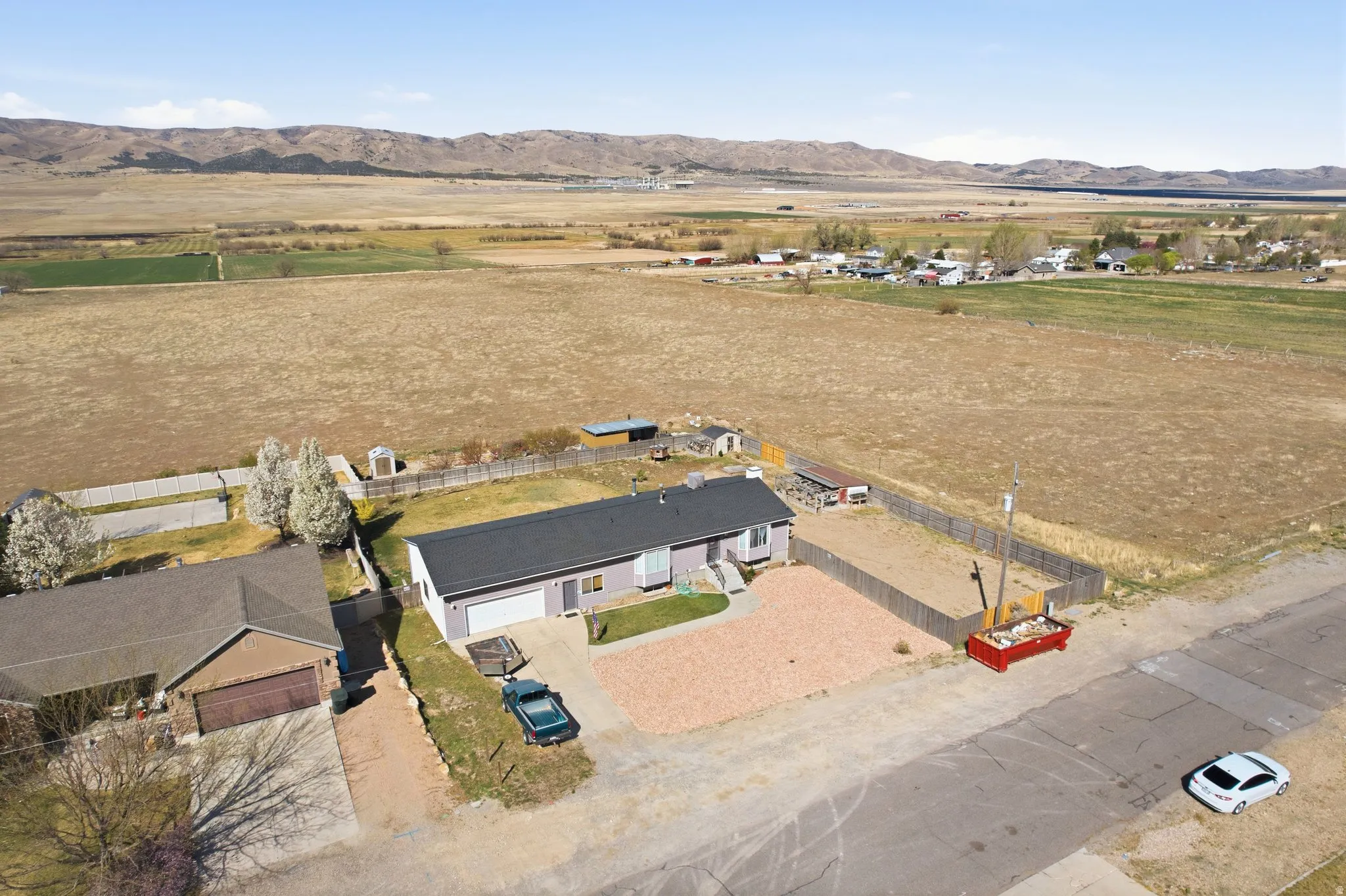 Aerial view of property's location with rural landscape and a mountainous background