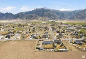 Aerial perspective showcasing a residential community with expansive mountain vistas