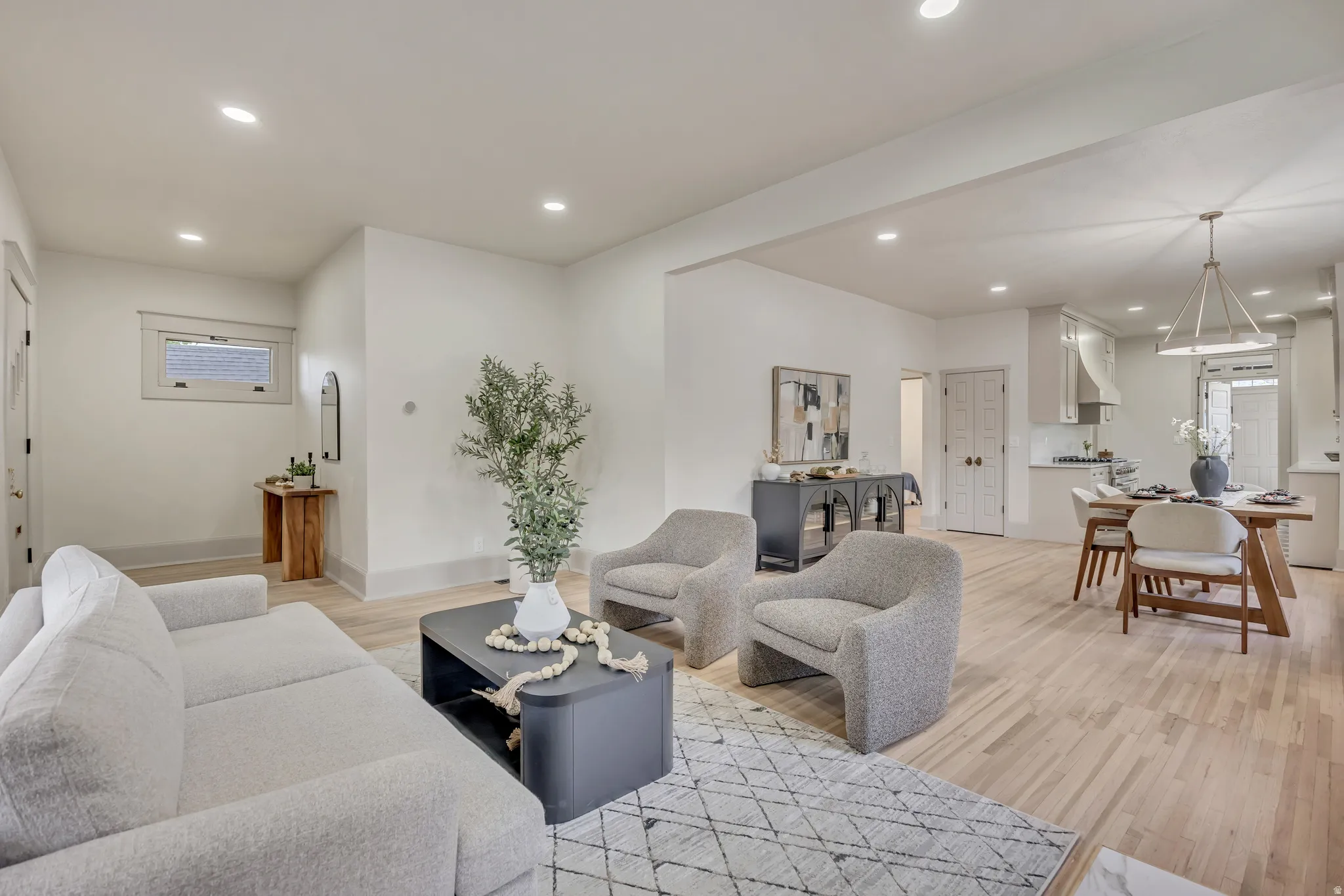 Living area with light wood-style floors and recessed lighting
