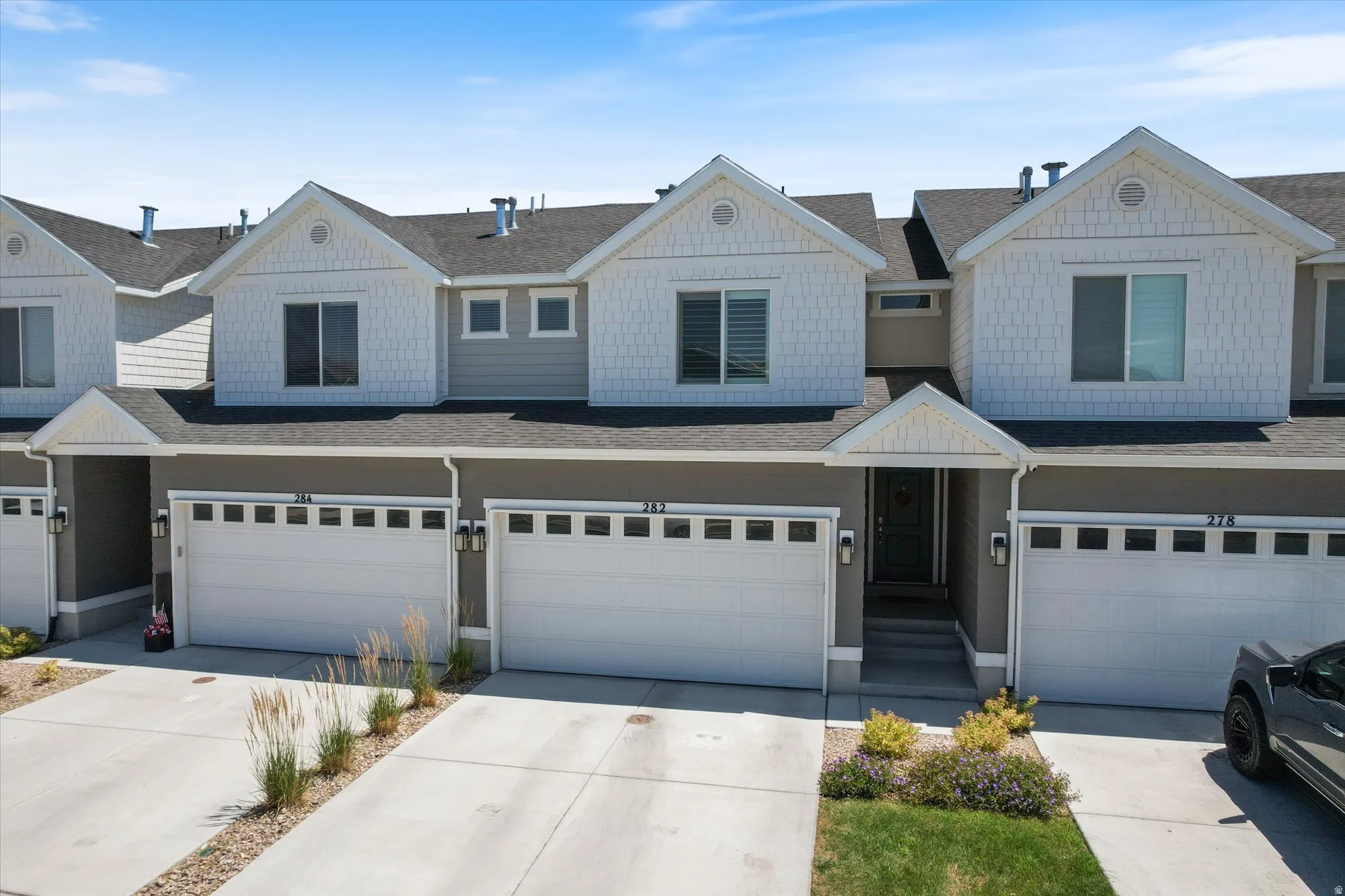 Craftsman inspired home with roof with shingles, concrete driveway, and an attached garage