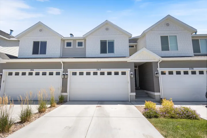 View of front of home featuring a garage and concrete driveway