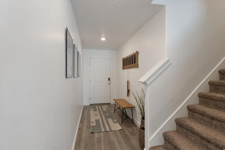 Hall with light wood finished floors and a textured ceiling