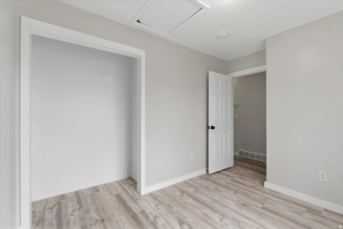 Unfurnished bedroom with light wood-style flooring and baseboards