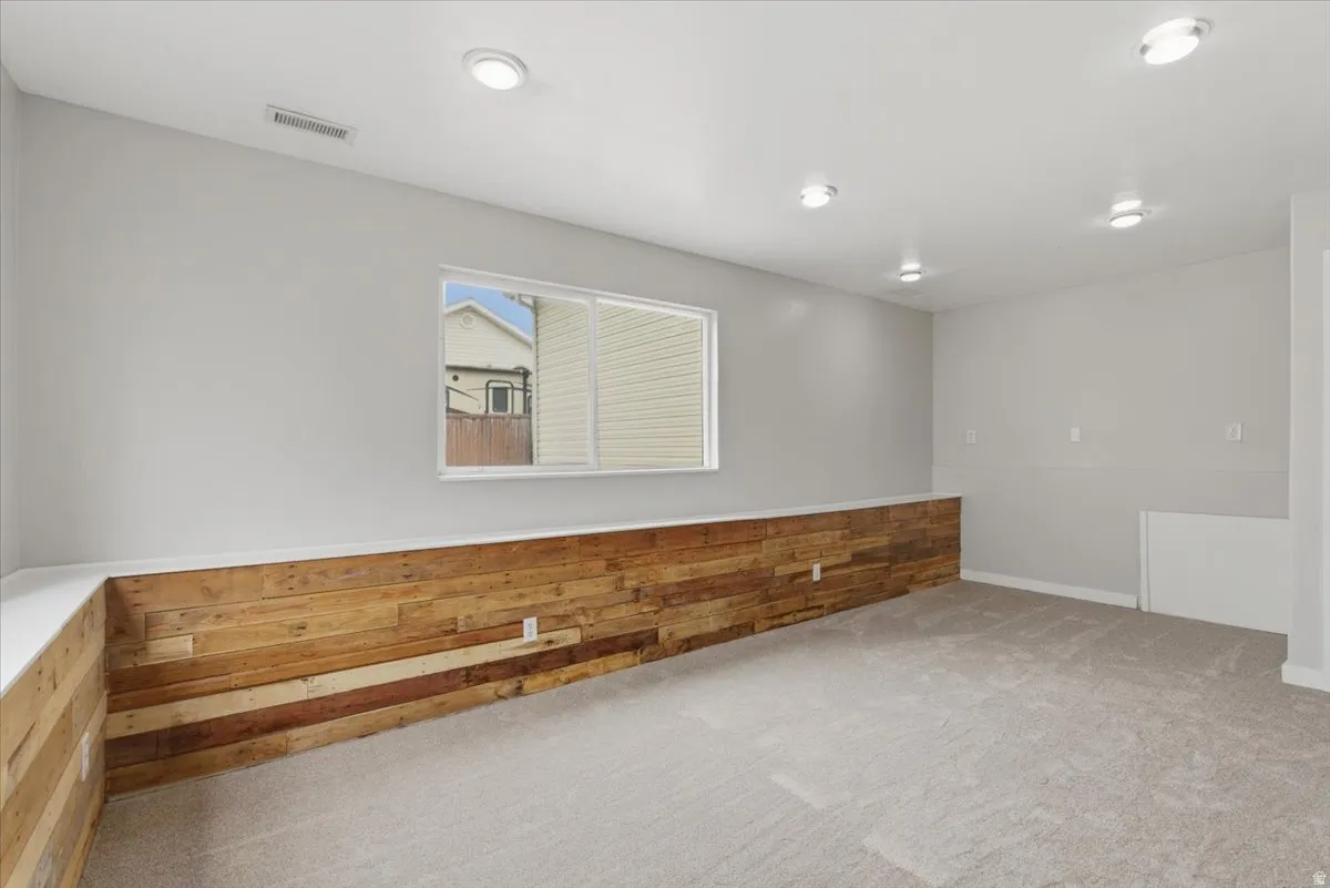 Unfurnished room featuring carpet flooring