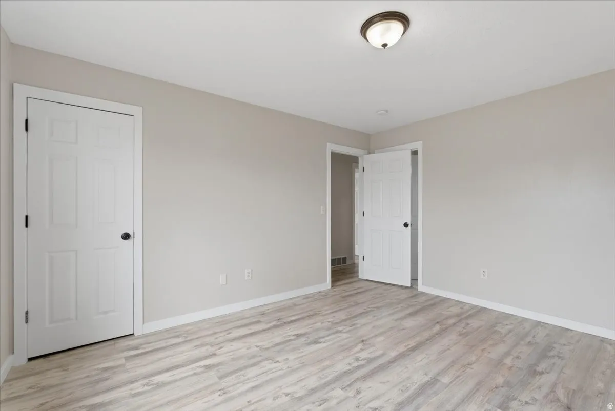 Unfurnished bedroom featuring light wood-type flooring