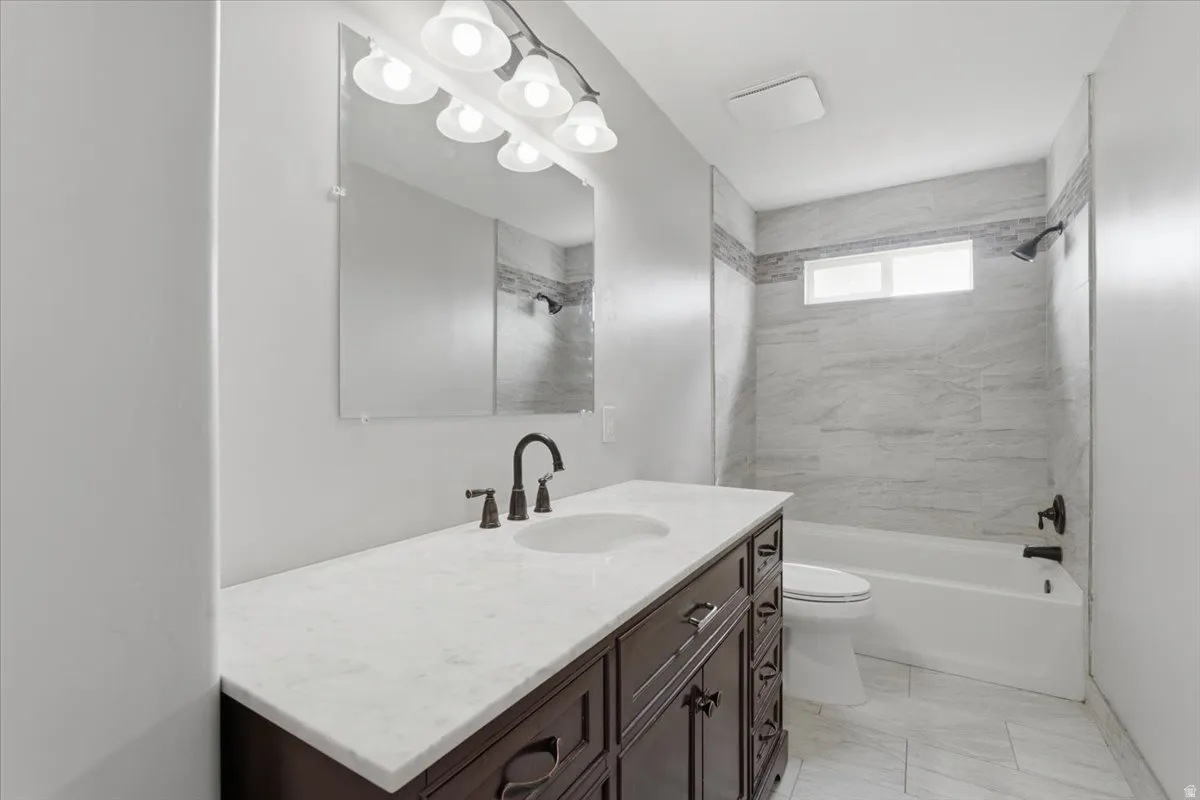 Full bathroom with vanity and washtub / shower combination