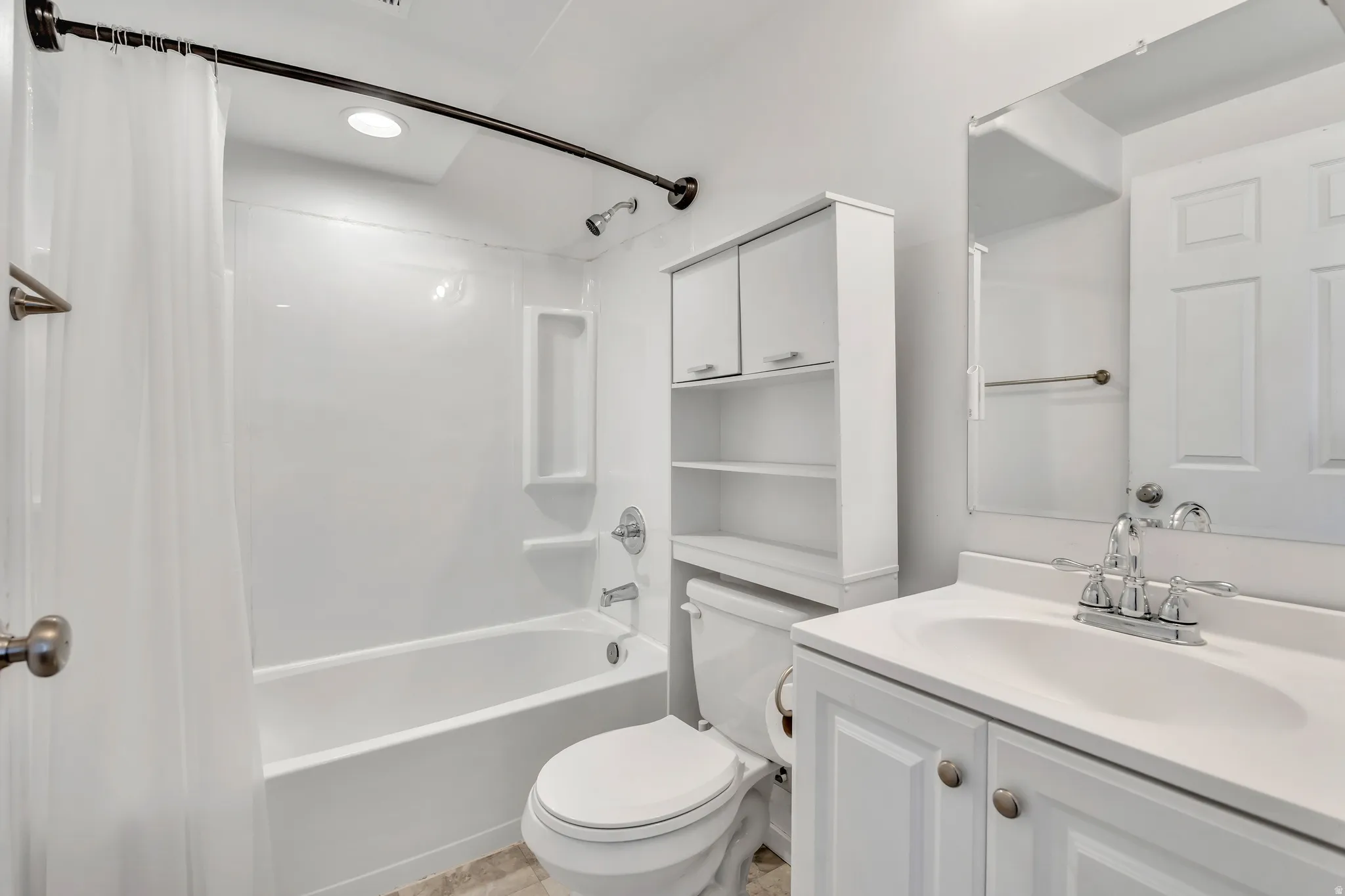 Bathroom with vanity and shower / bath combination with curtain