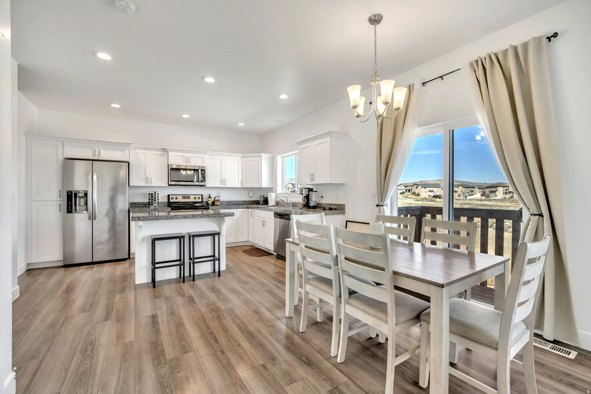 Dining space featuring suspended lighting and light wood-type flooring