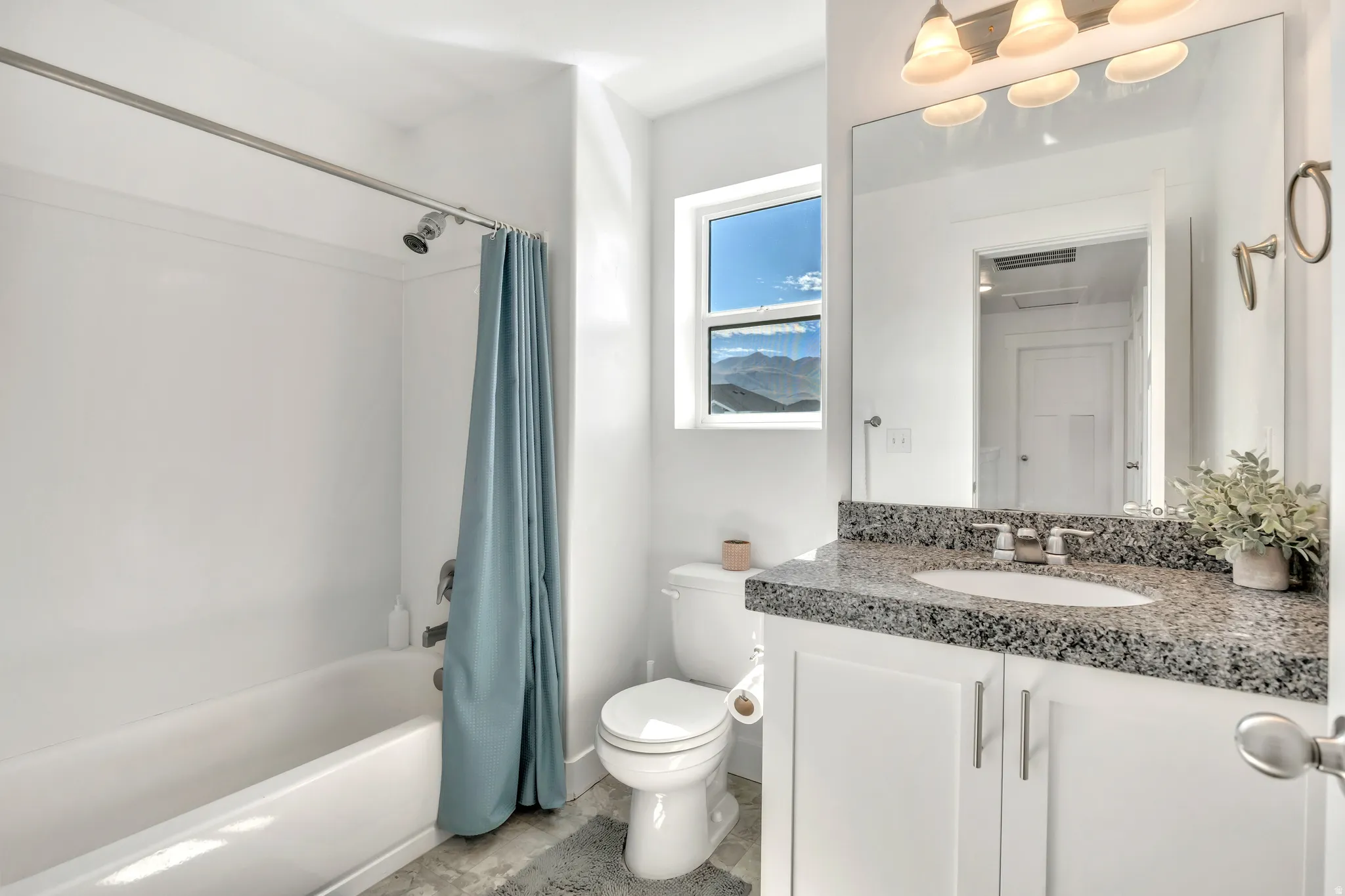 Bathroom with vanity and shower / bath combination with curtain