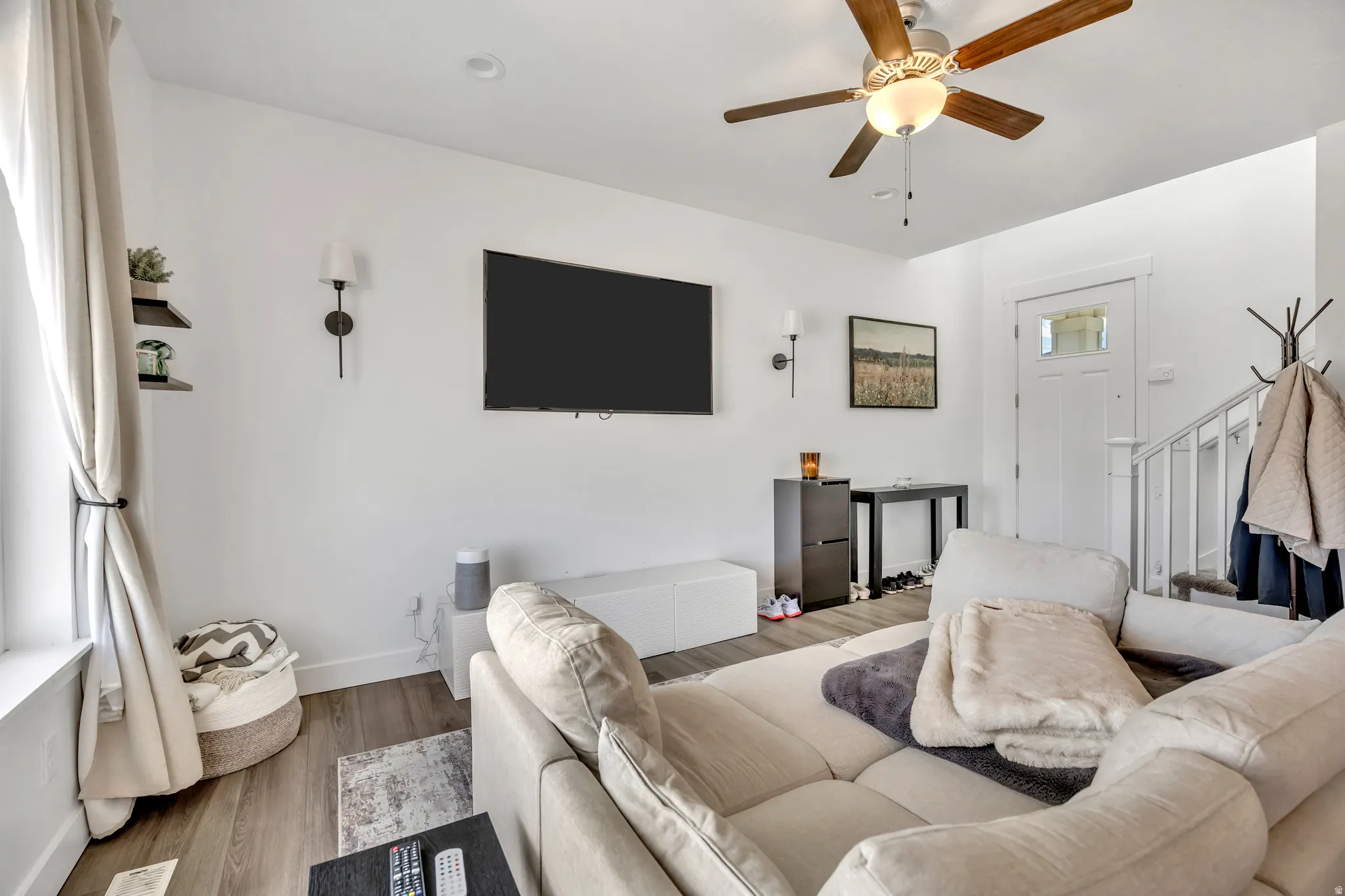 Living room with a ceiling fan and wood finished floors