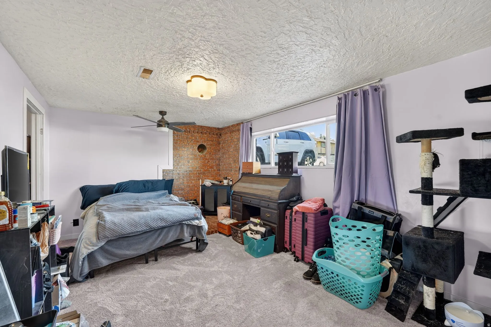 Living room featuring a textured ceiling and a ceiling fan