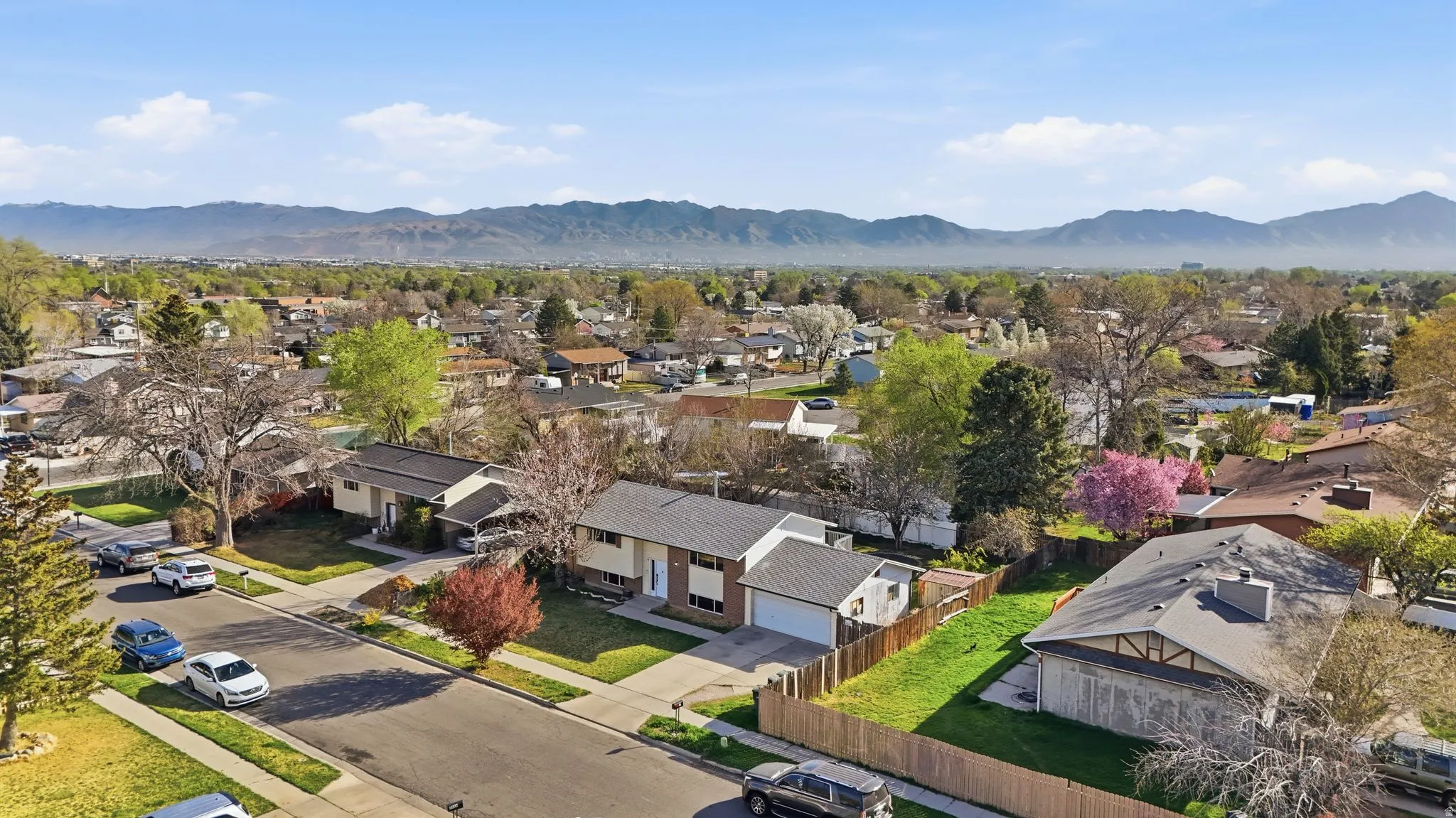 Aerial perspective of suburban area with a mountainous background
