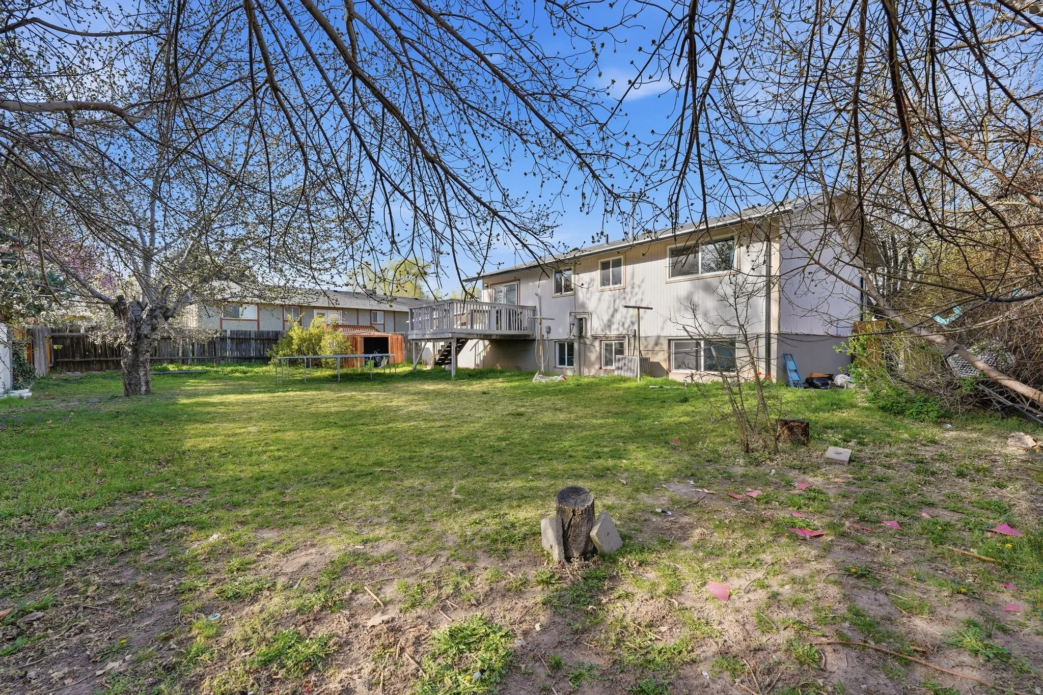 Back of house with a wooden deck and stairs
