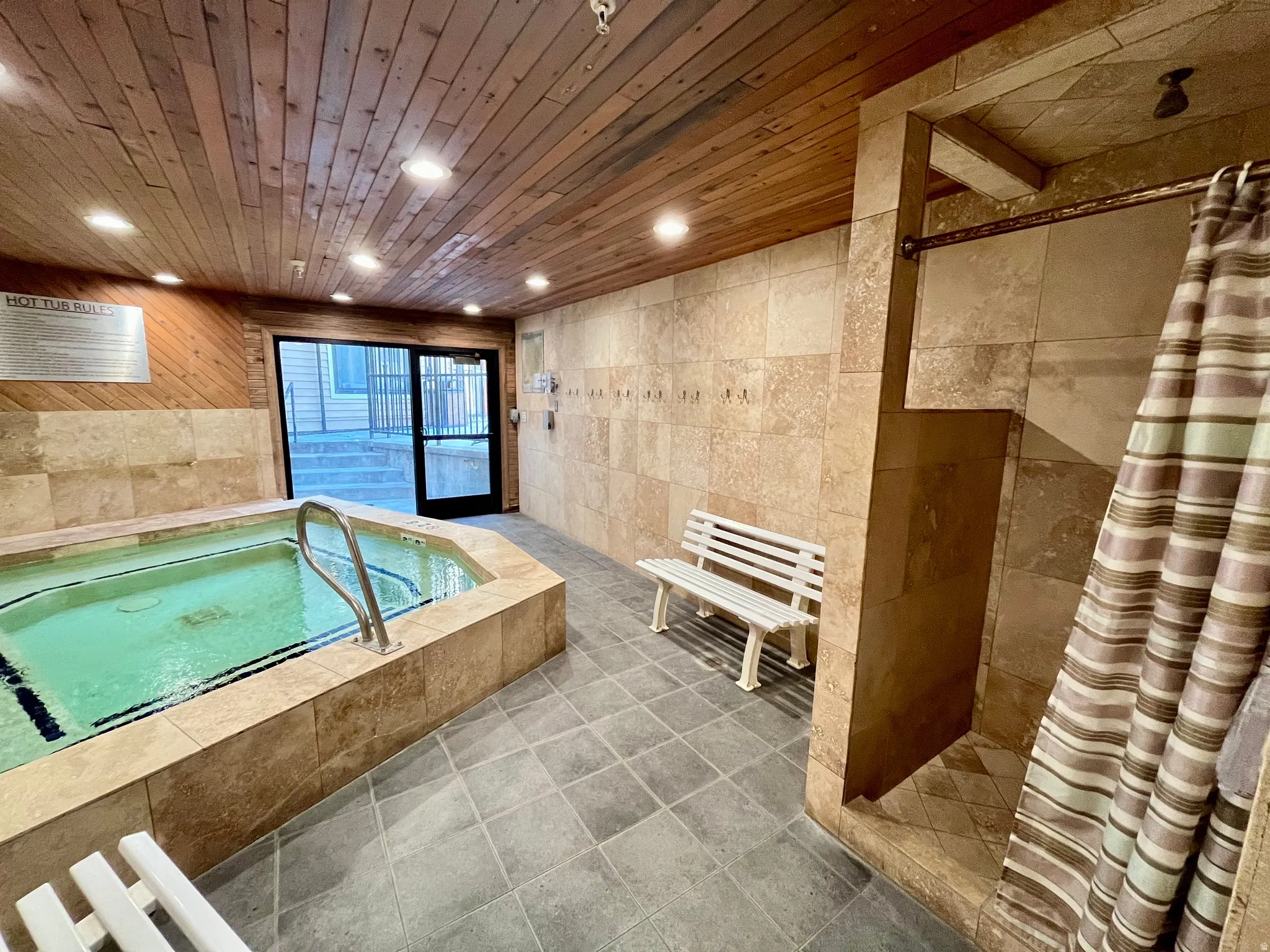 Bathroom with tile walls, a stall shower, a bath, recessed lighting, and tile patterned floors