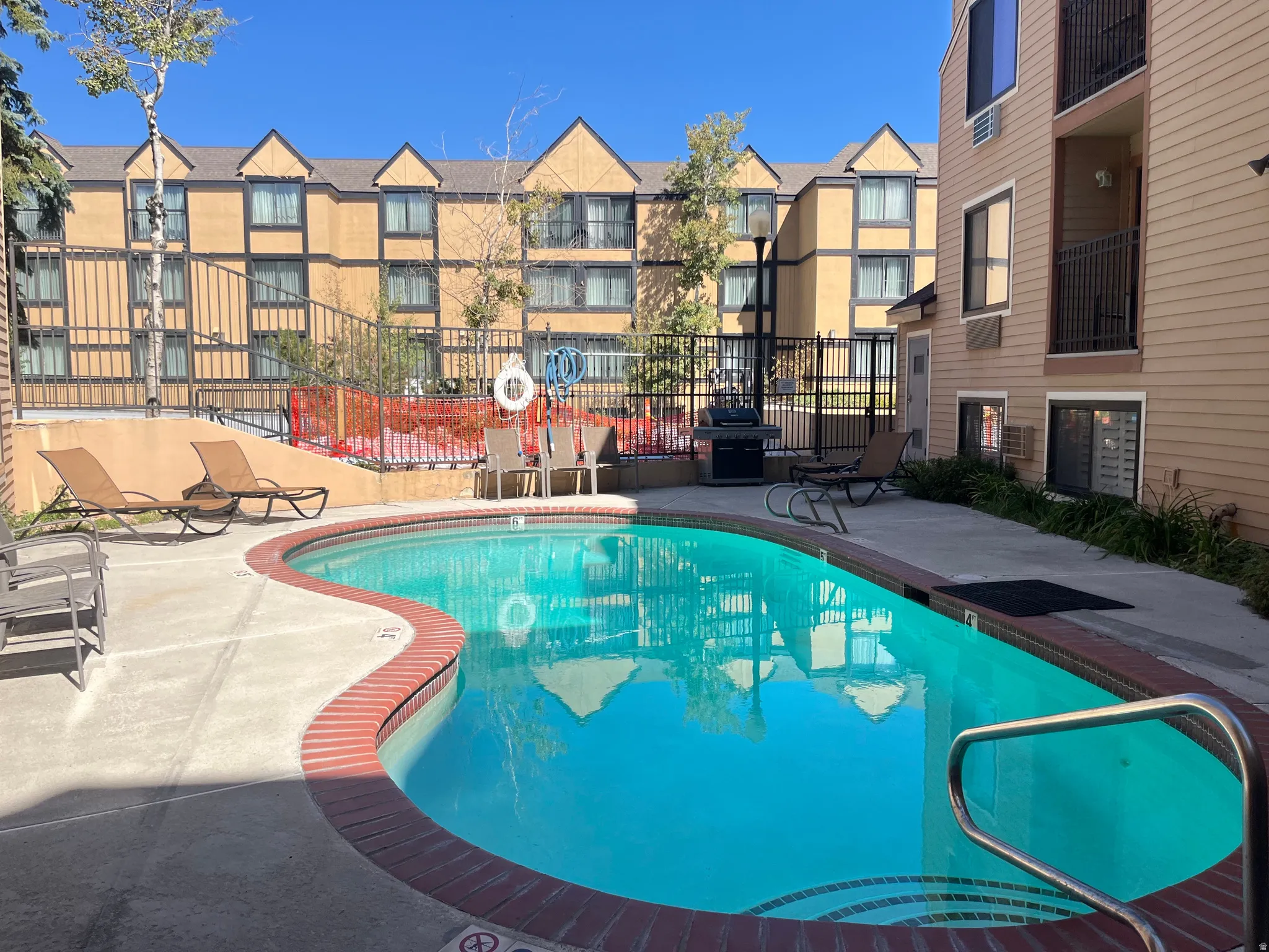 Community pool featuring a patio area and grilling area
