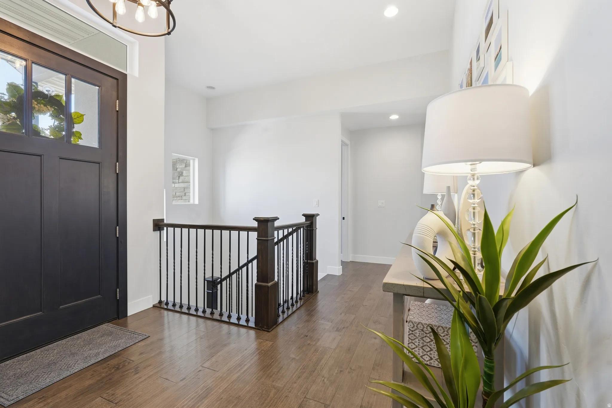 Foyer featuring hardwood flooring and hanging lights